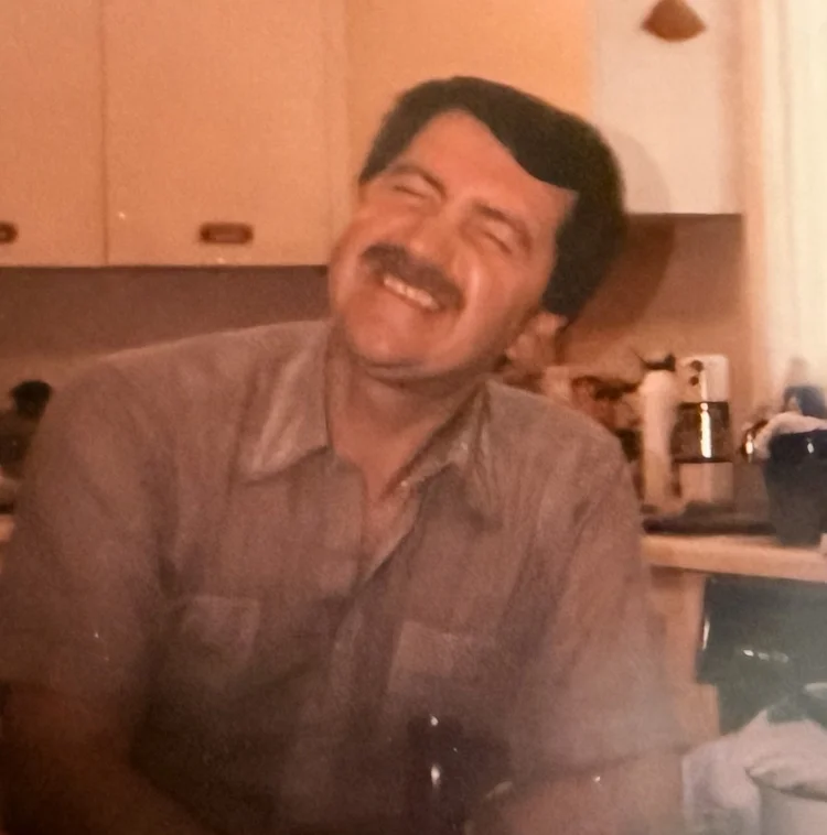 A father laughing in his kitchen