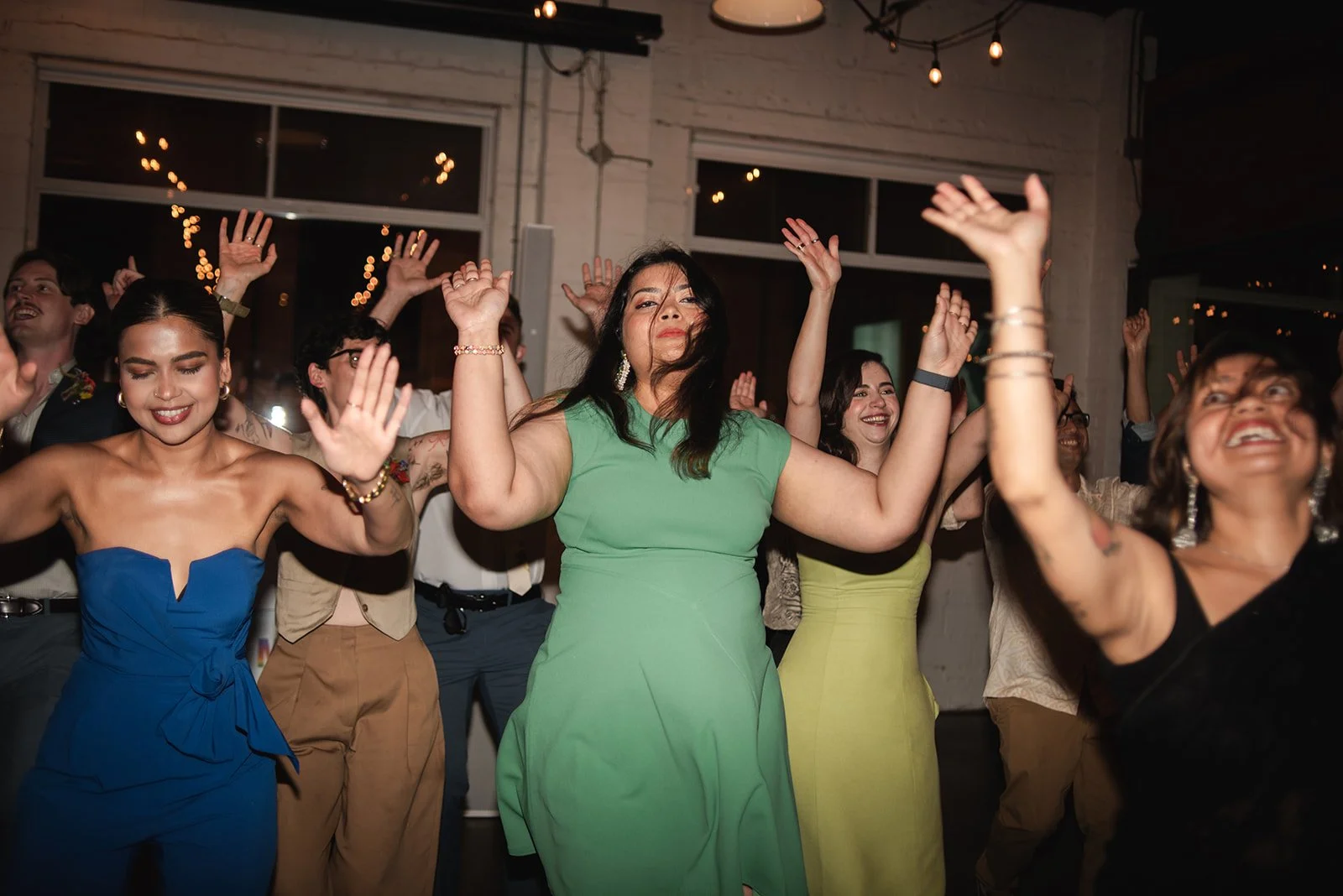  wedding guests perform a traditional South Asian dance at Brides wedding at Propeller Coffee Co.’s event space in Toronto. 