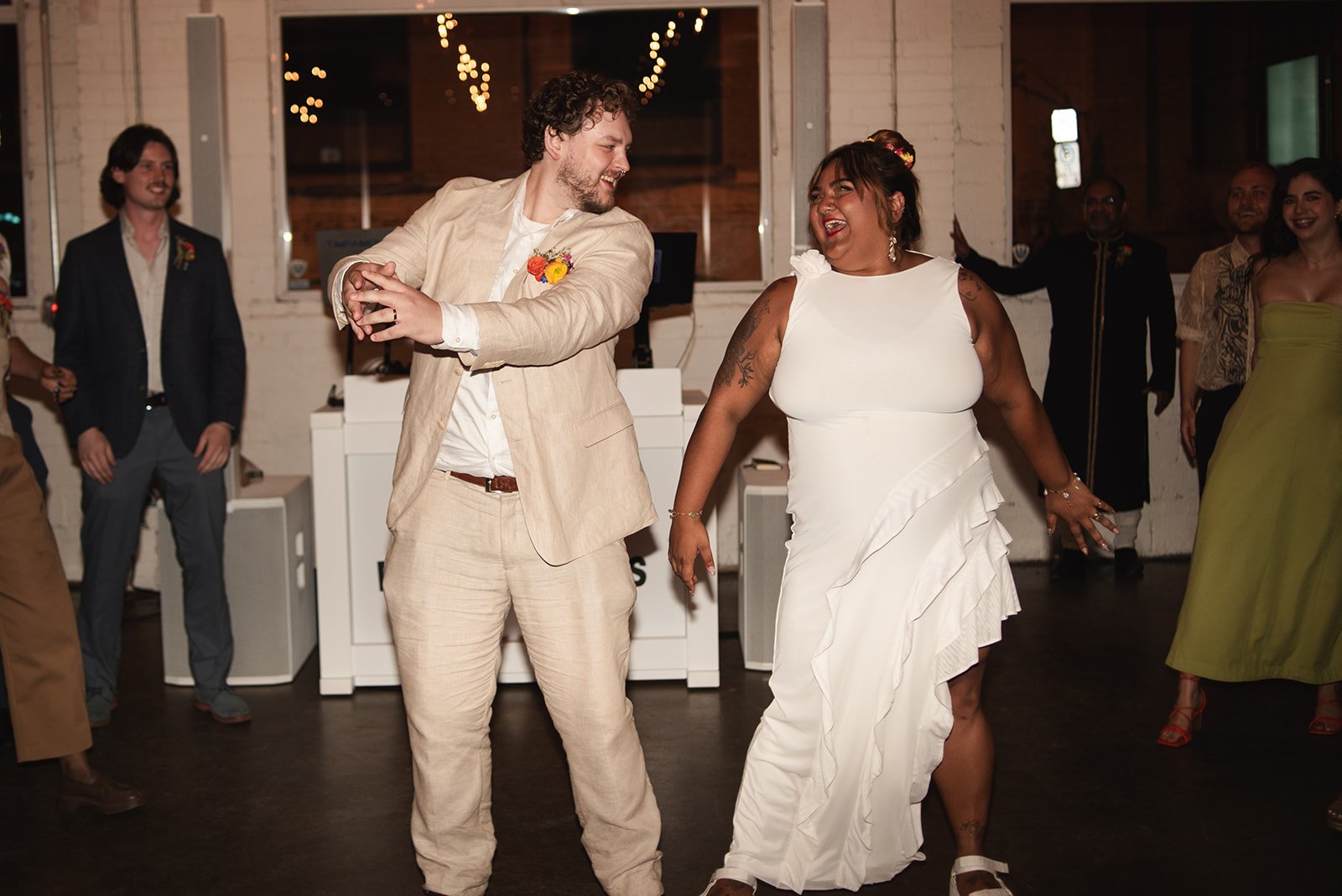  Bride and Groom take part in a traditional South Asian dance at Brides wedding at Propeller Coffee Co.’s event space in Toronto. 