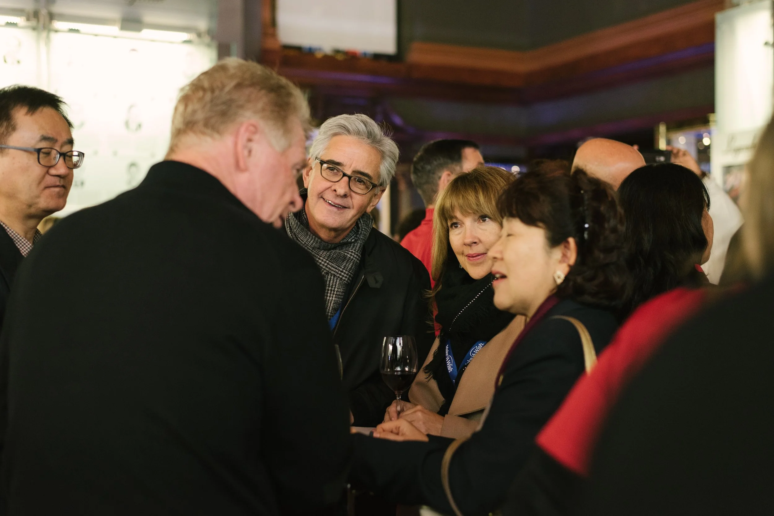 Group of people engaged in conversation at a social gathering.