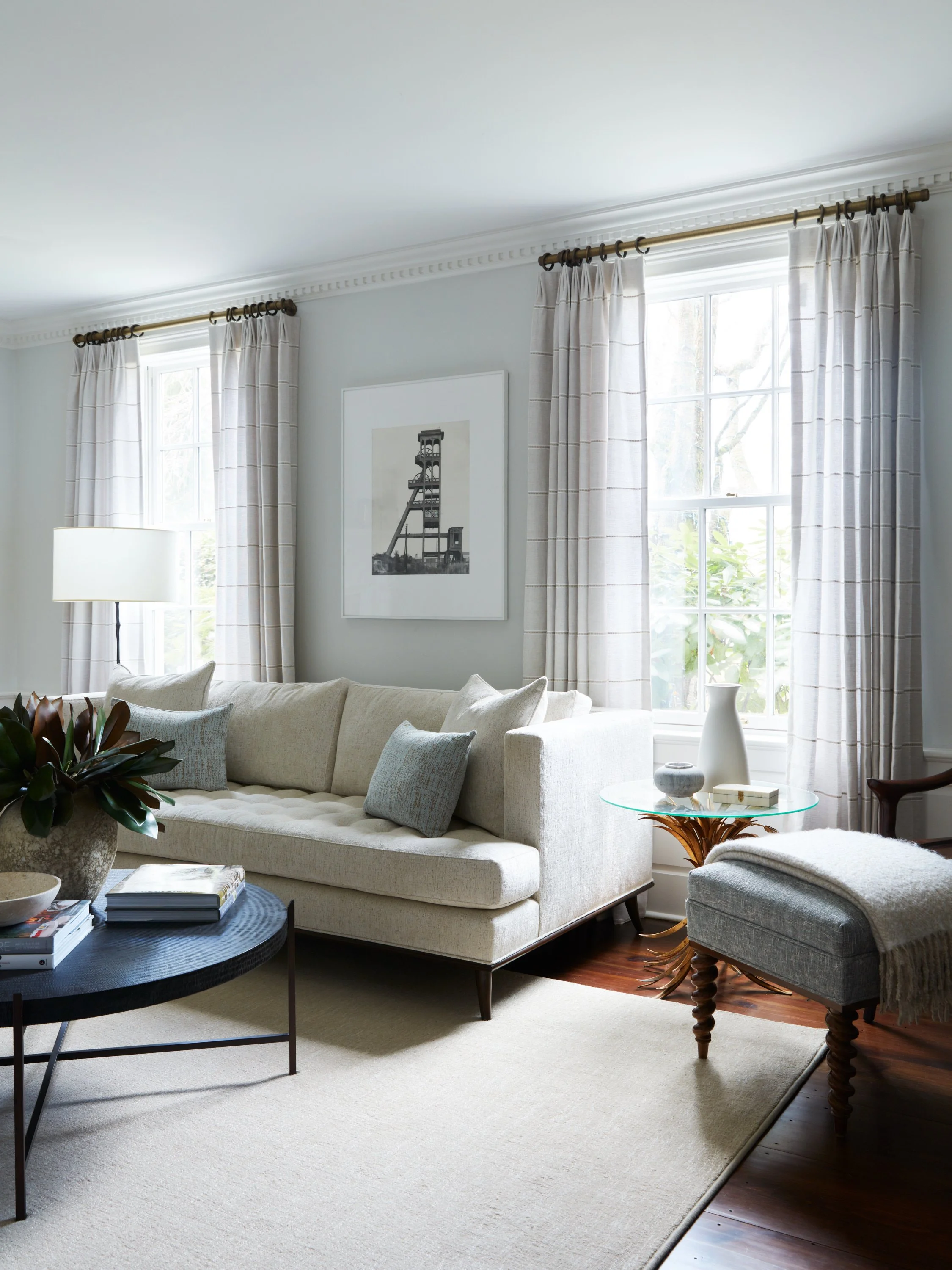 Living room window with neutral linen drapery panels.