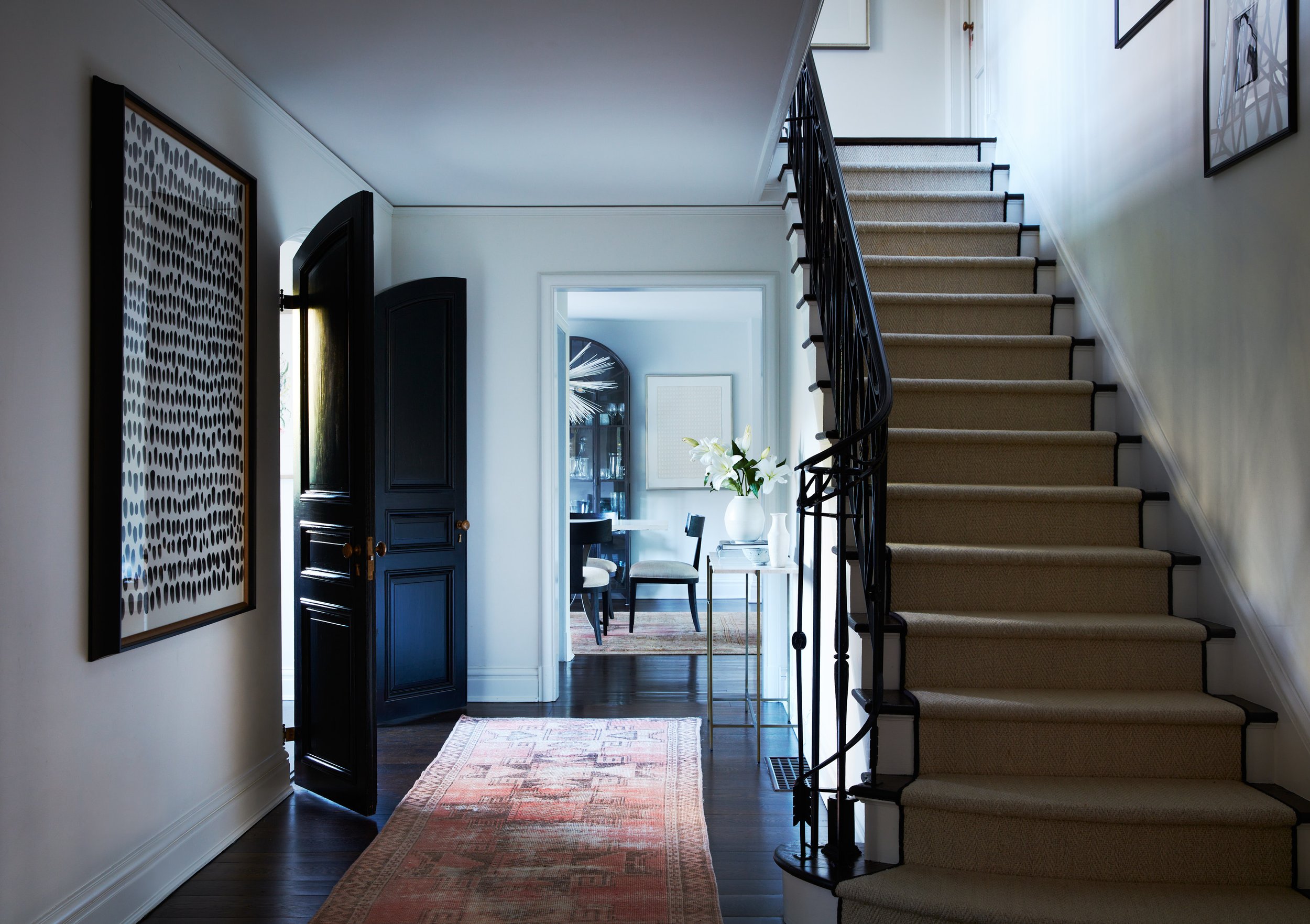 Stair hall with improved sightlines in a renovated historic Westchester home.