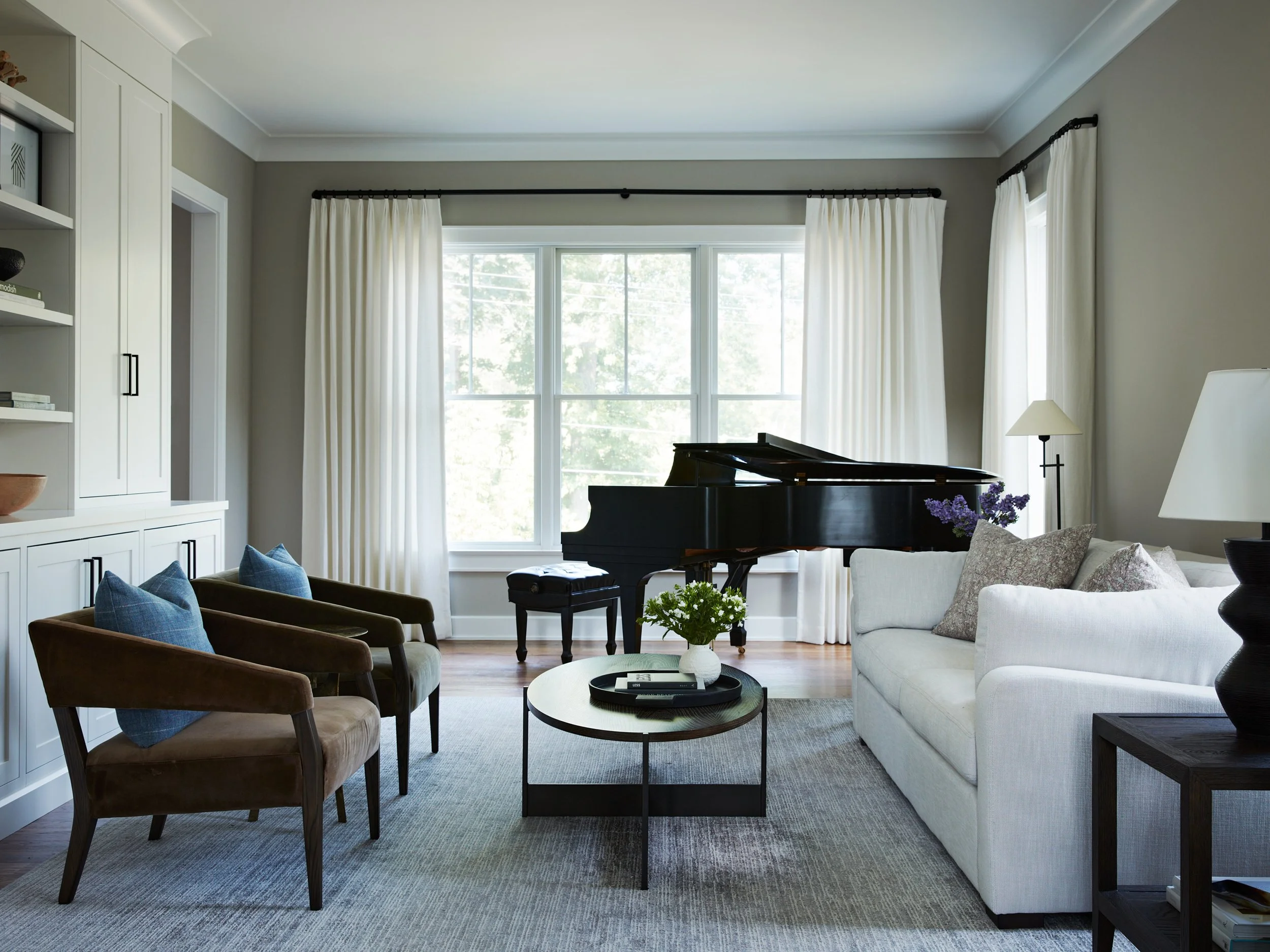Floor-to-ceiling drapery panels framing large living room windows.