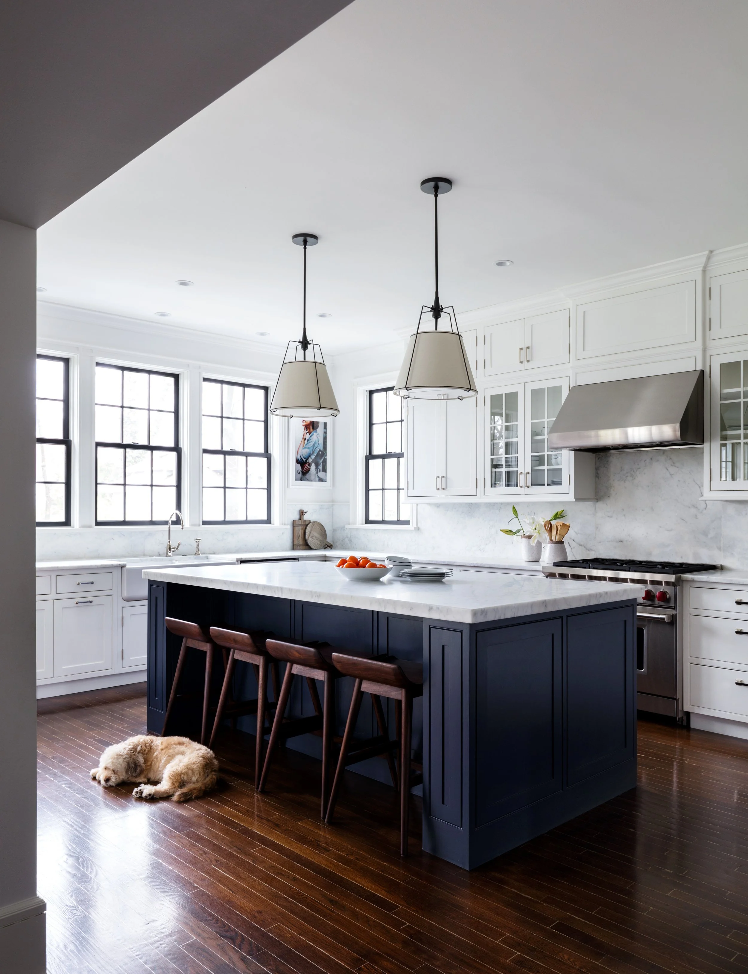 Large open kitchen with a navy blue island and improved circulation.