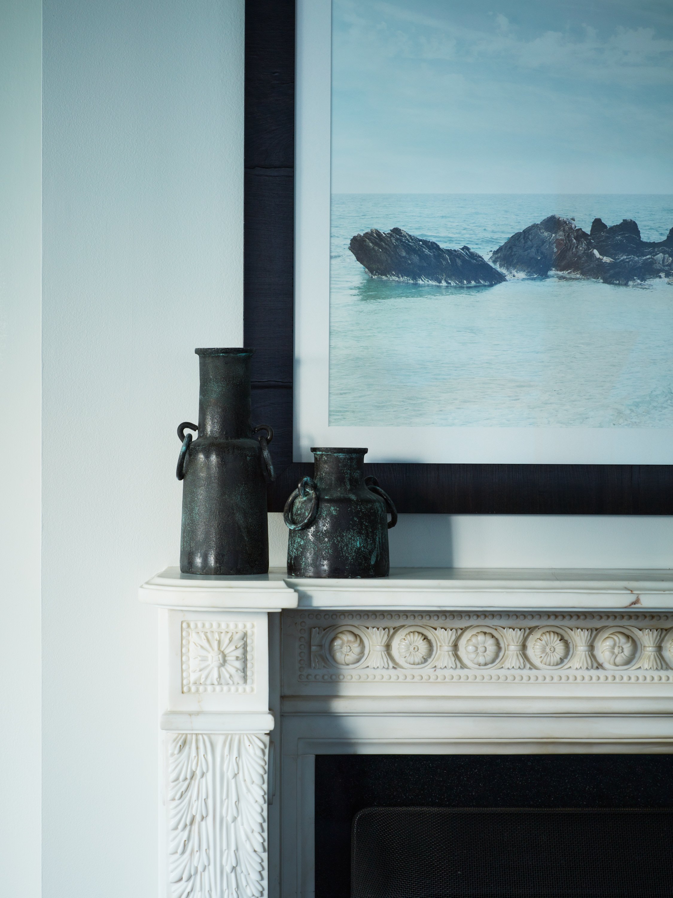 Preserved historic marble fireplace mantel in a formal living room.