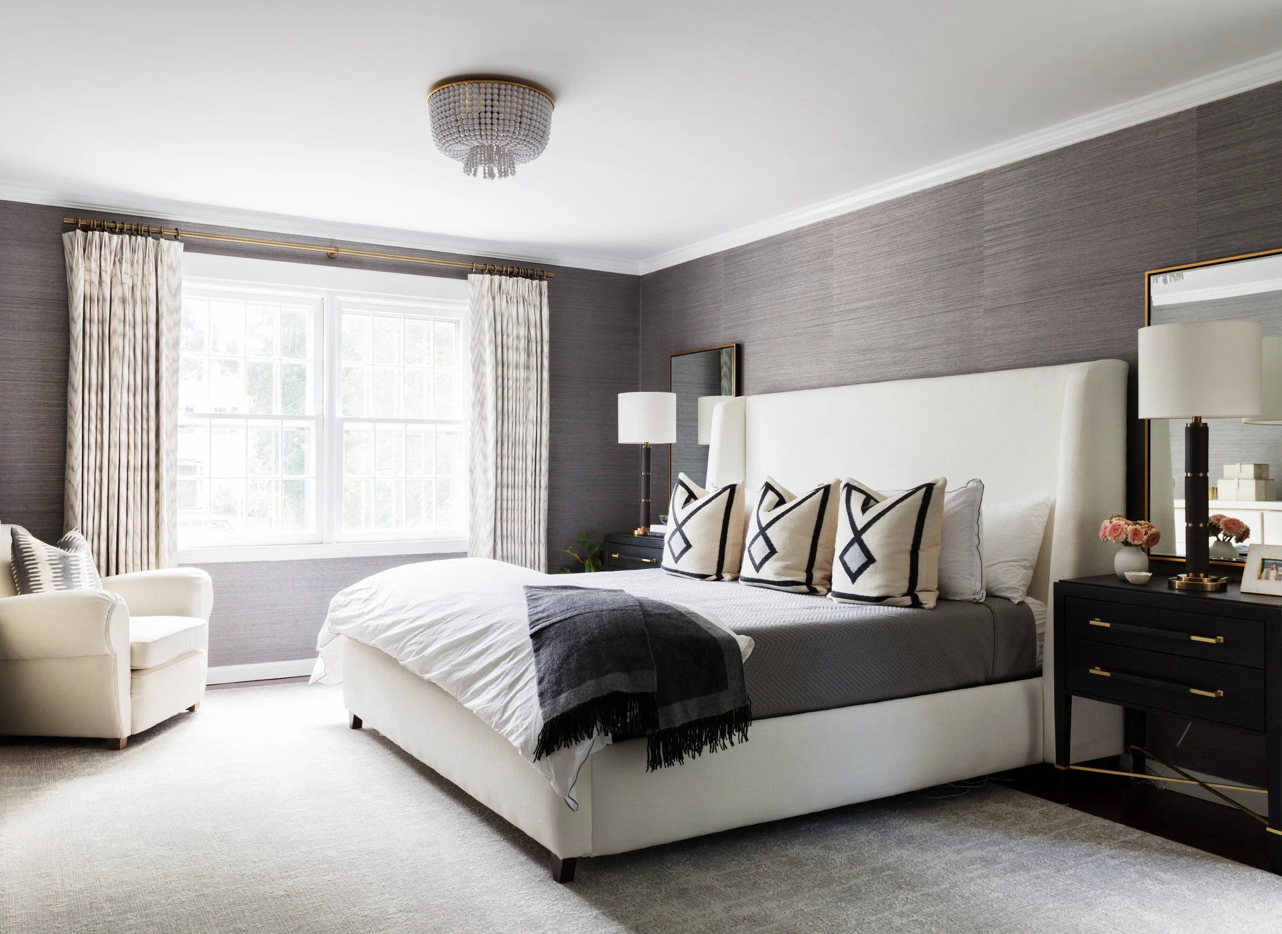 Soft linen drapery panels with tailored pleats in a traditional living room.