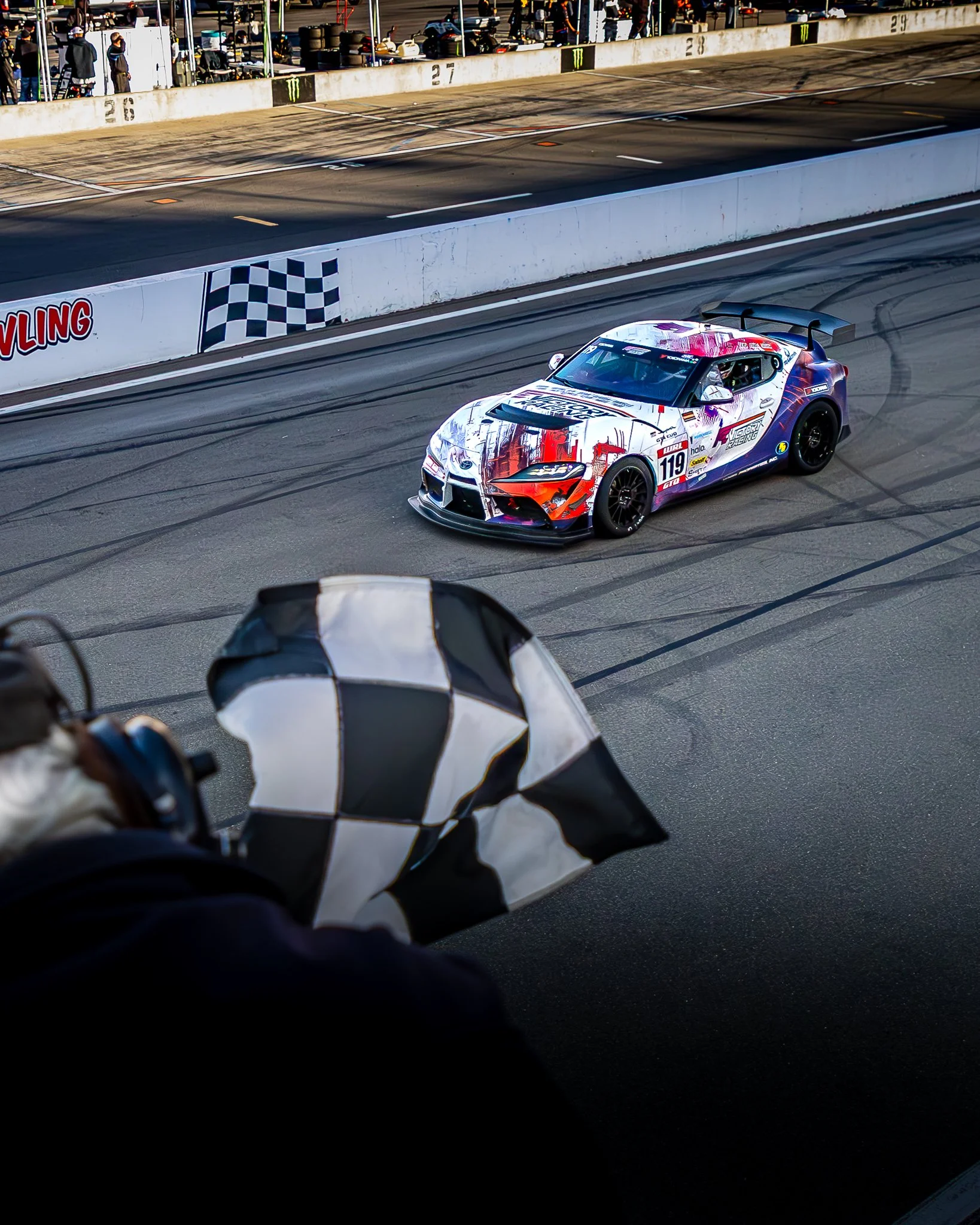 Stella driving past the checkered flag