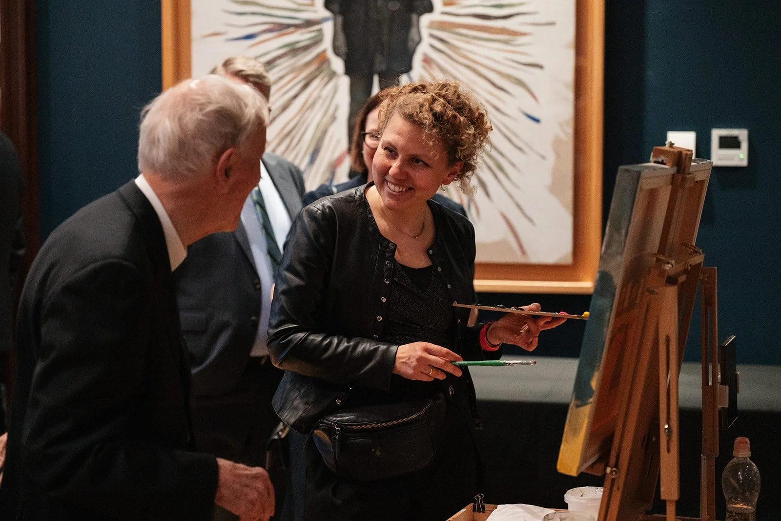 Guests watching live event painter at gala dinner