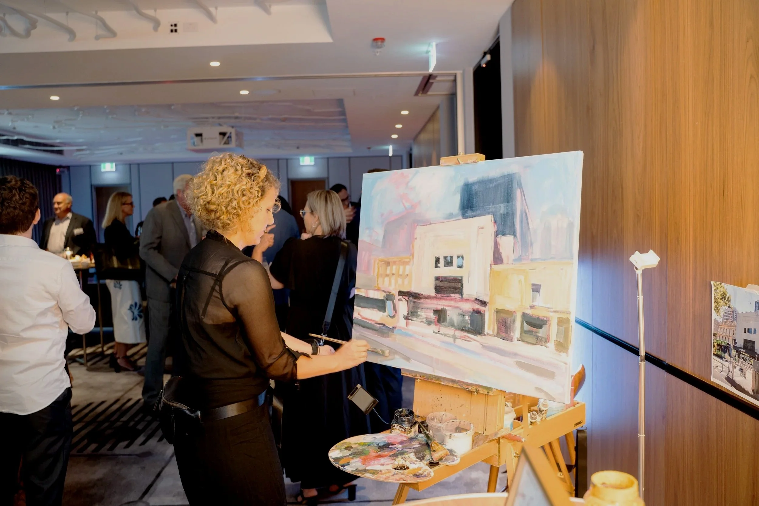 Olga painting a hotel at Melbourne venue