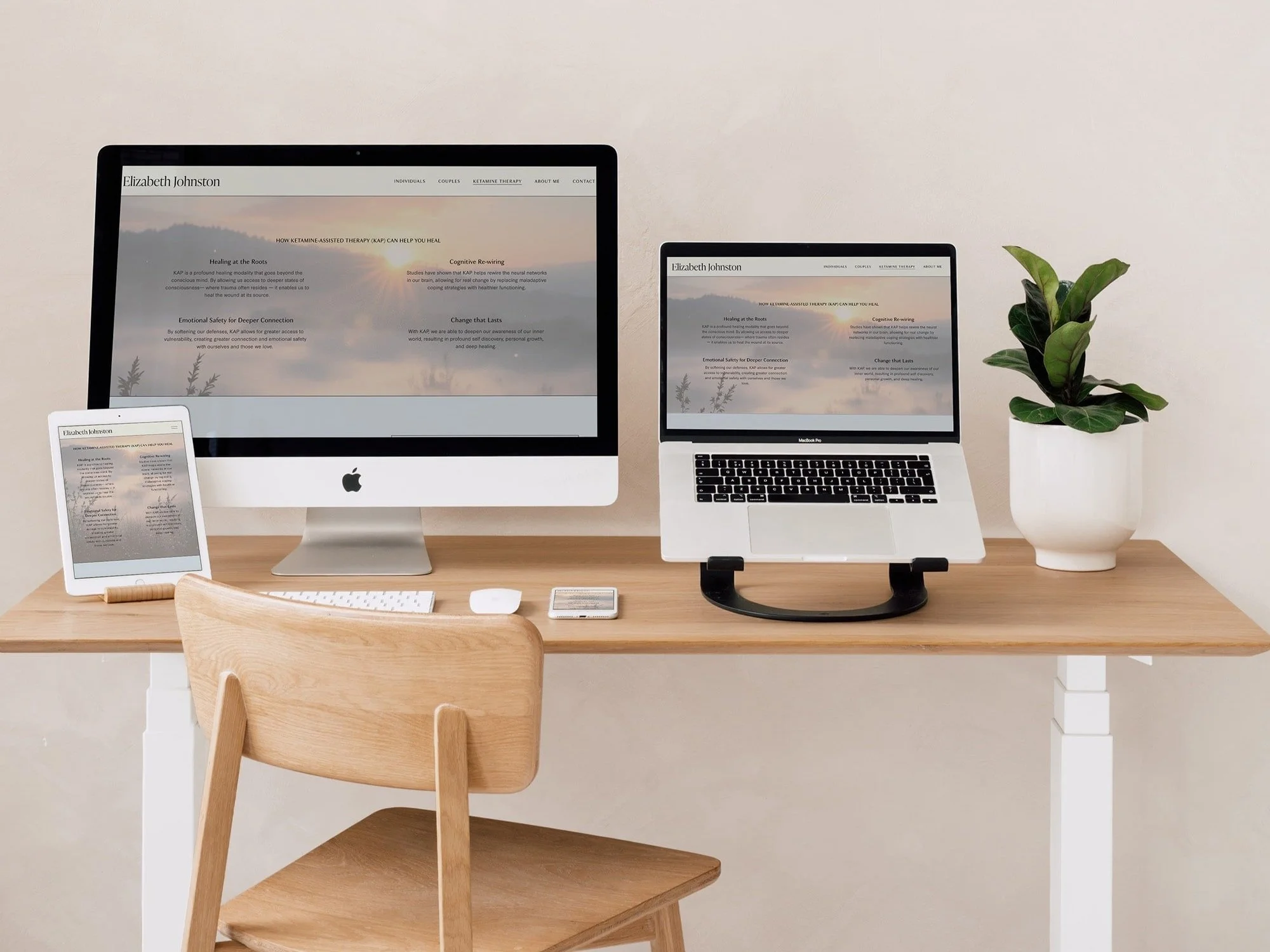 A desktop, laptop, tablet, and smartphone on top of a desk, all displaying a custom therapist website.