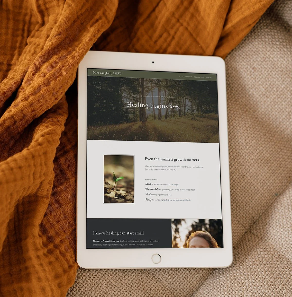 A tablet on top of a beige couch and orange blanket.  The tablet displays a custom therapist website homepage for Mira Langford, LMFT.  There is an image of a sprout and the text "Even the smallest growth matters."