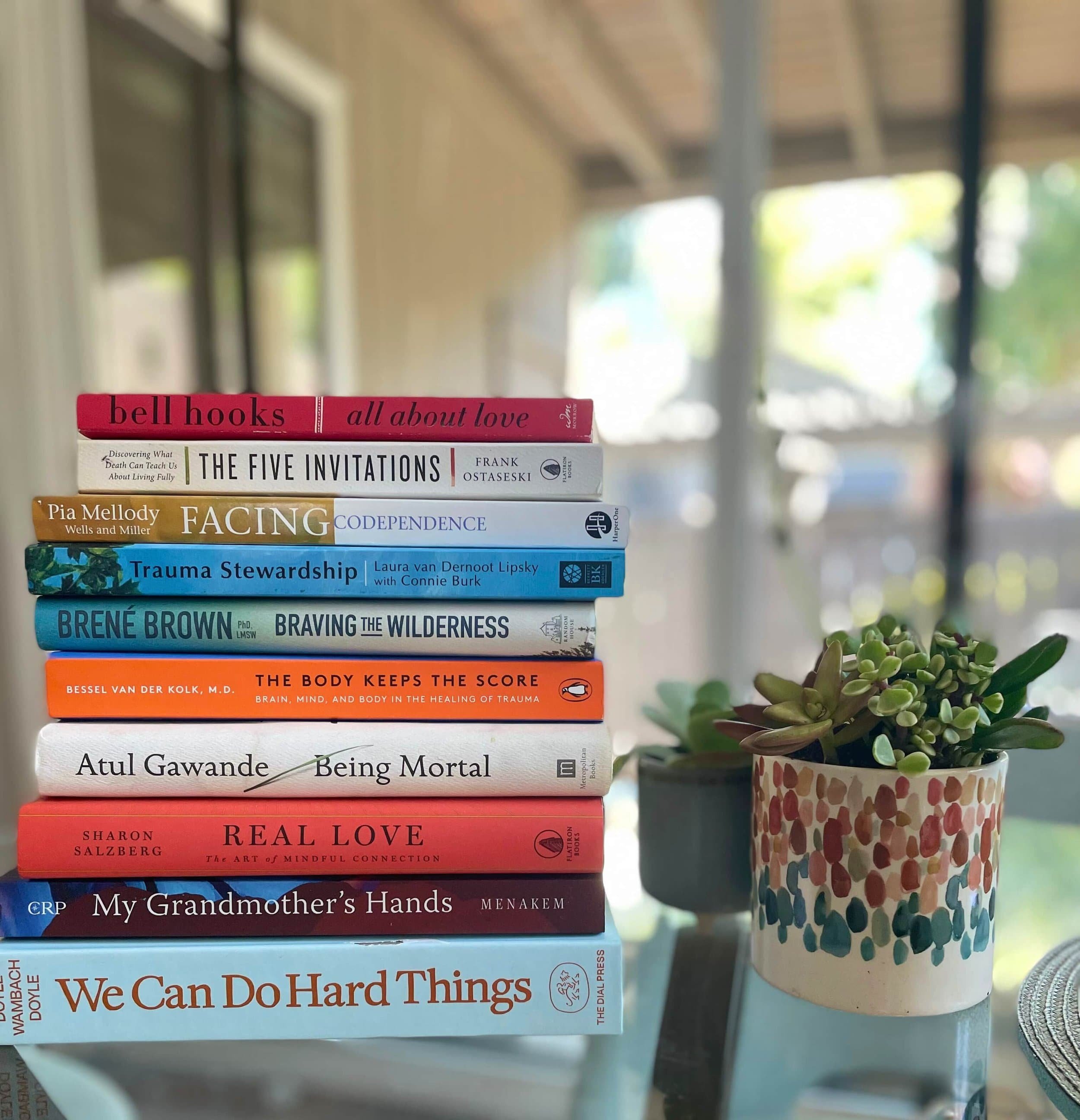 A stack of self help books on a table