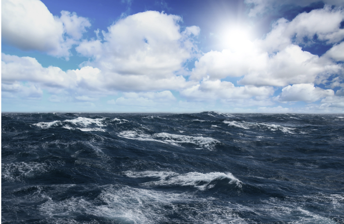 A wide open ocean with choppy dark waves under a bright sunlit sky with scattered clouds, representing the emotional turbulence and inner storms that many trauma survivors experience, held within the broader context of light and possibility explored