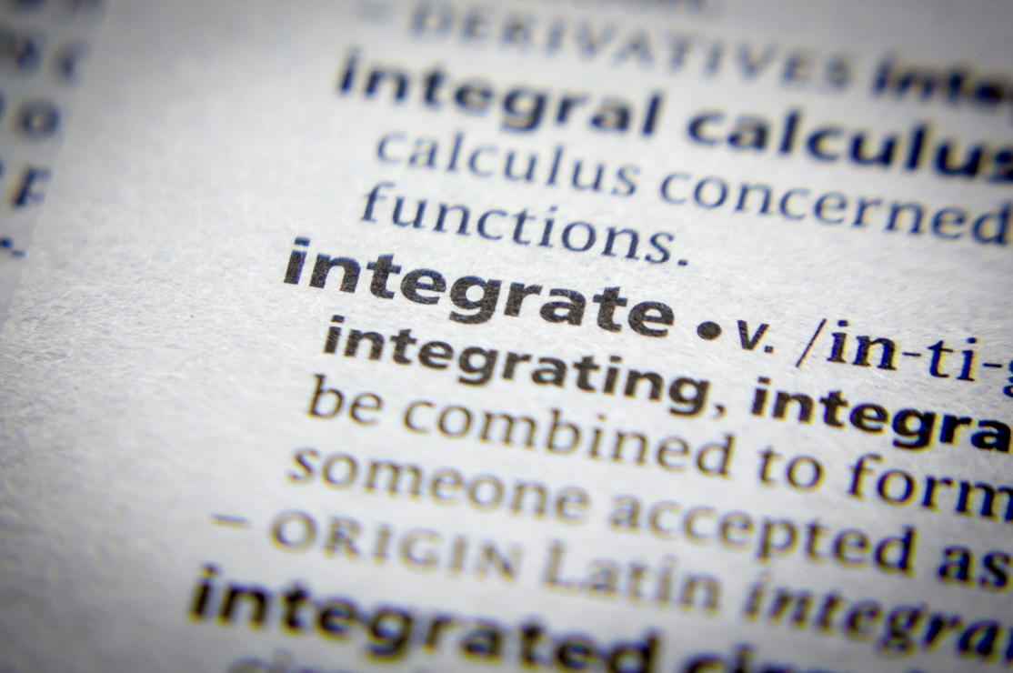 Close-up of a dictionary entry for the word integrate, used in the context of Malachi Gillihan's integrative approach to trauma recovery, which combines Eastern and Western healing traditions with somatic and mind-body practices