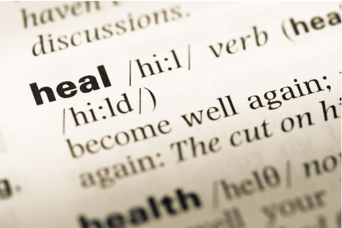 Close-up of a dictionary entry for the word heal, used as a visual anchor for the core mission of Malachi Gillihan's integrative trauma recovery practice in Berkeley, CA