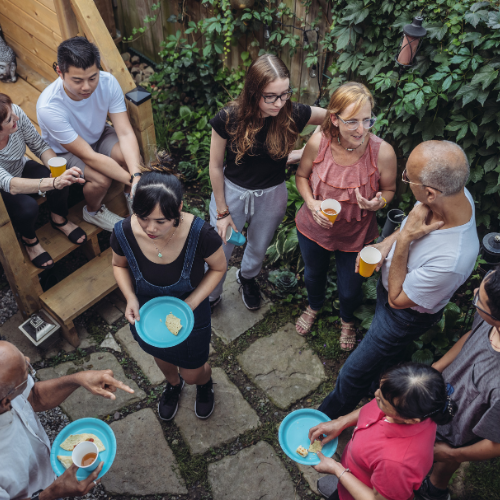 Residential community gathering with neighbors socializing outdoors, highlighting resident events and community engagement at an apartment property.