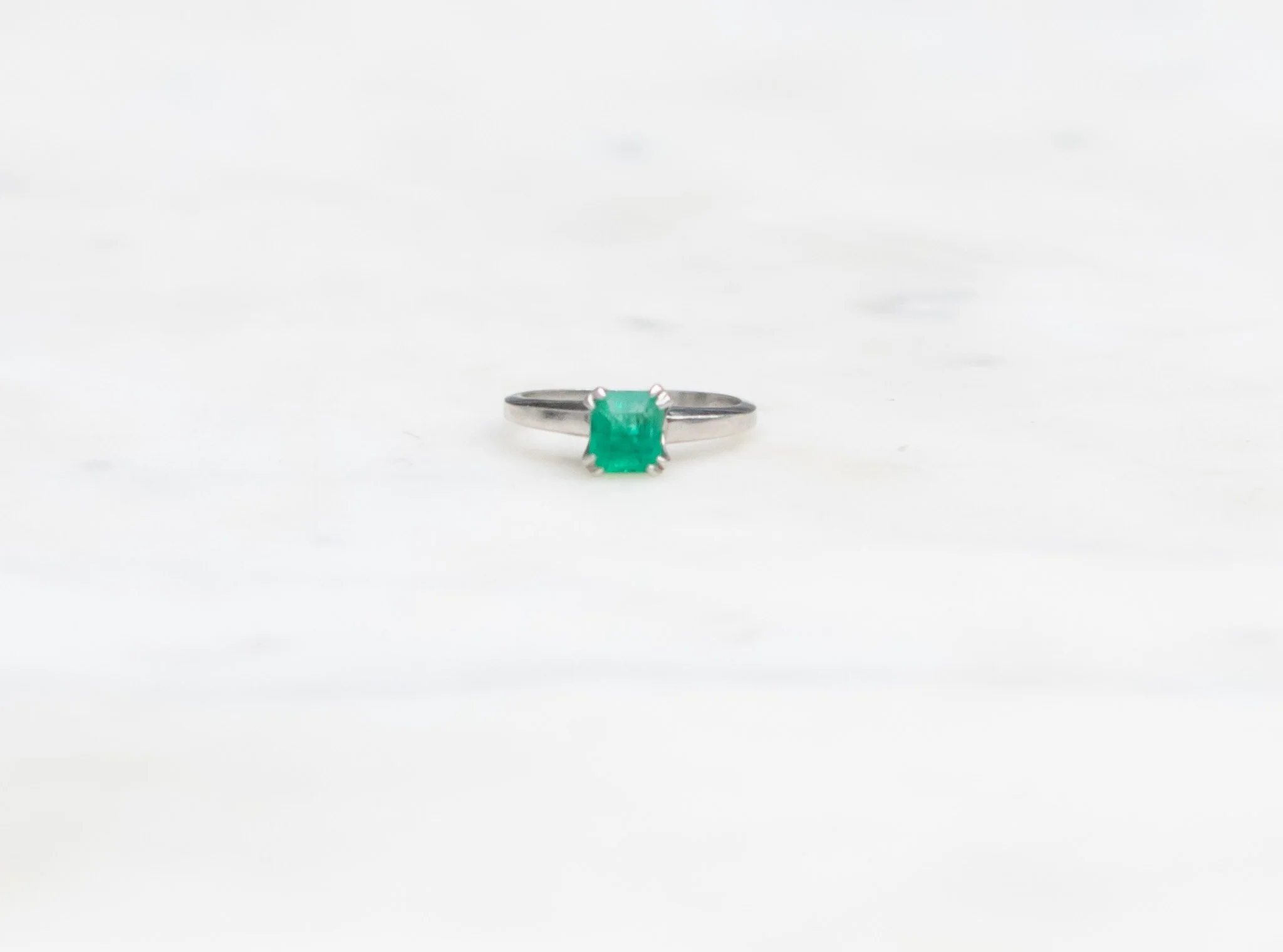 Platinum ring with emerald-cut emerald.