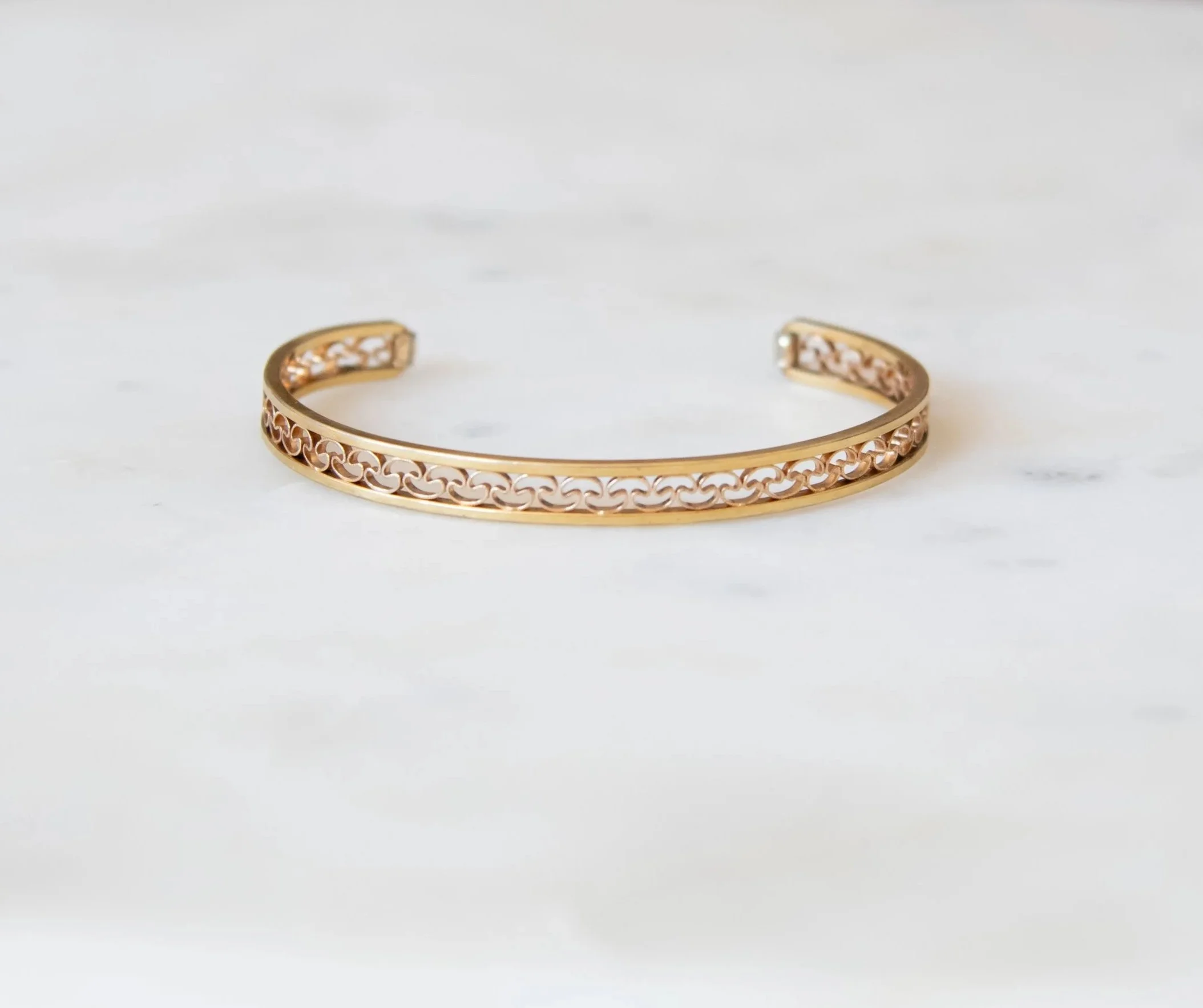 Antique 14K gold cuff with open-work fauna motif design.