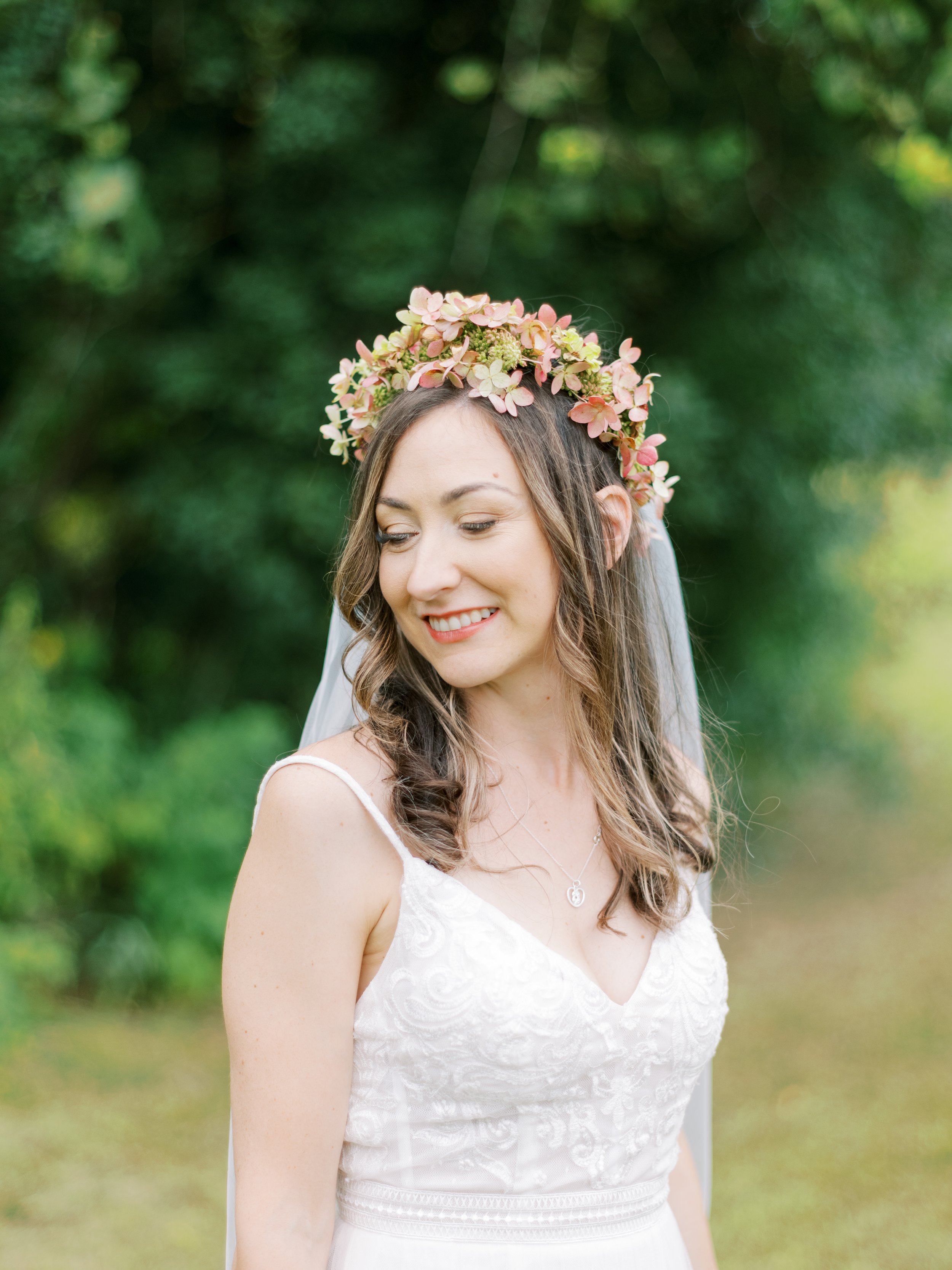 Bride with floral crown and white dress outdoors