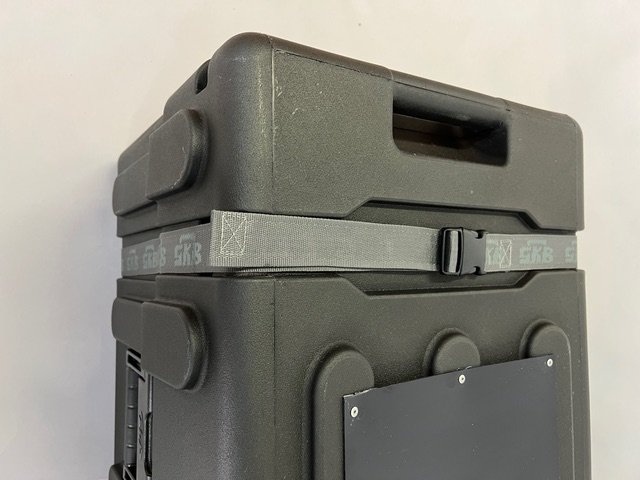 black shipping case with 6'x 6' x 1'D shelf wall display with 2 cinch straps