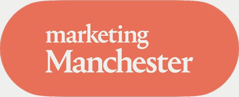 Text reading 'marketing Manchester' on a rounded red background.