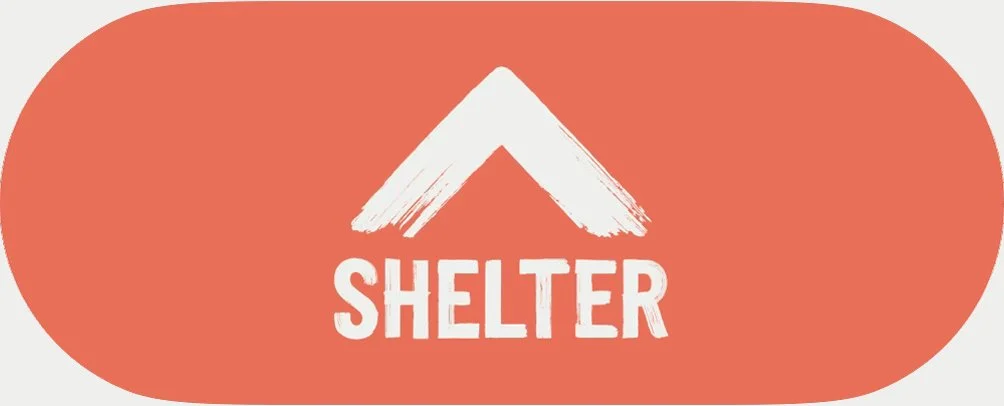 Red oval background with a white mountain-like icon above the word 'SHELTER' in bold white letters.