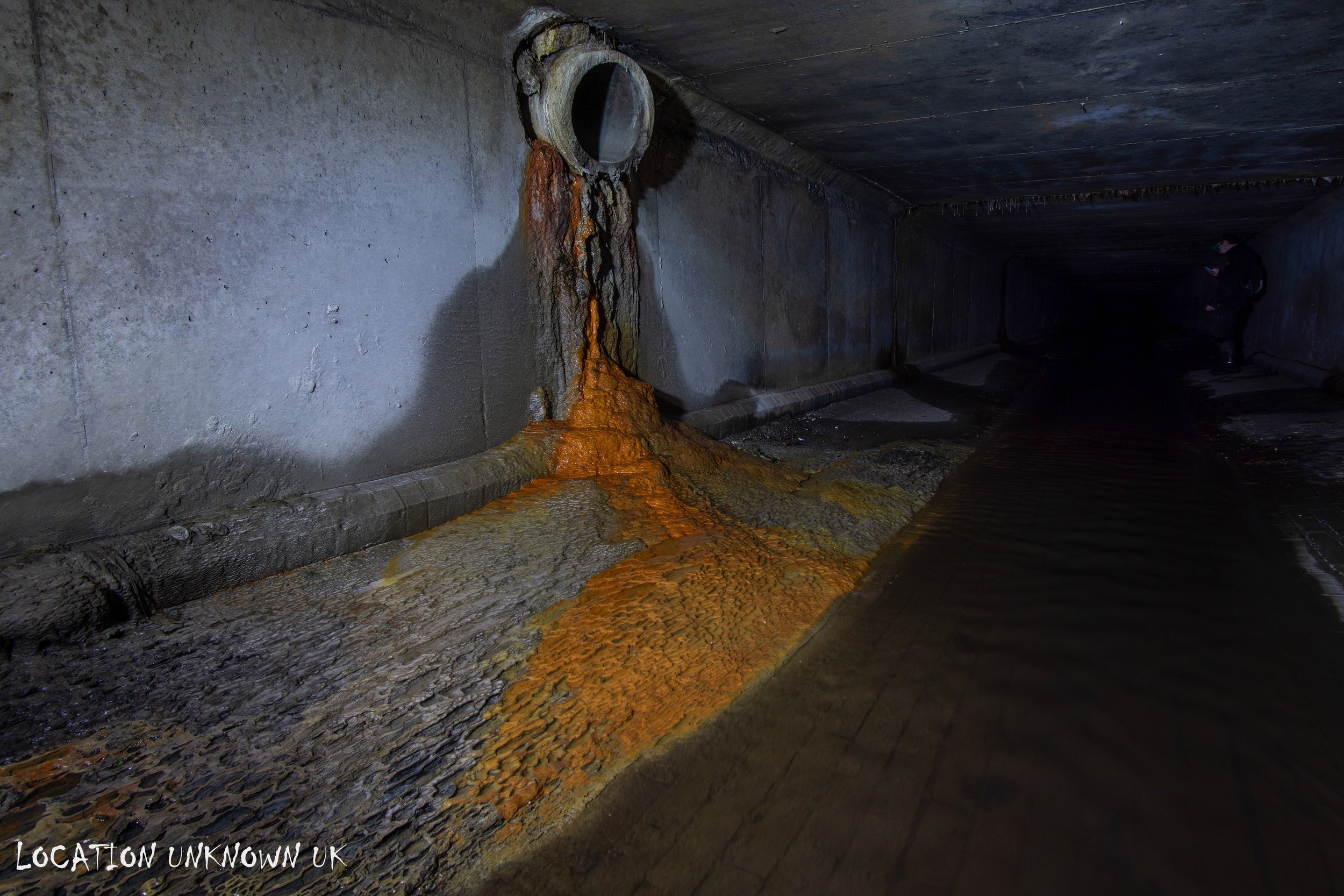Ochre staining, this phenomenon is common in places with high iron content in the soil or water, particularly in older, unlined drainage systems where groundwater seeps into the pipes.