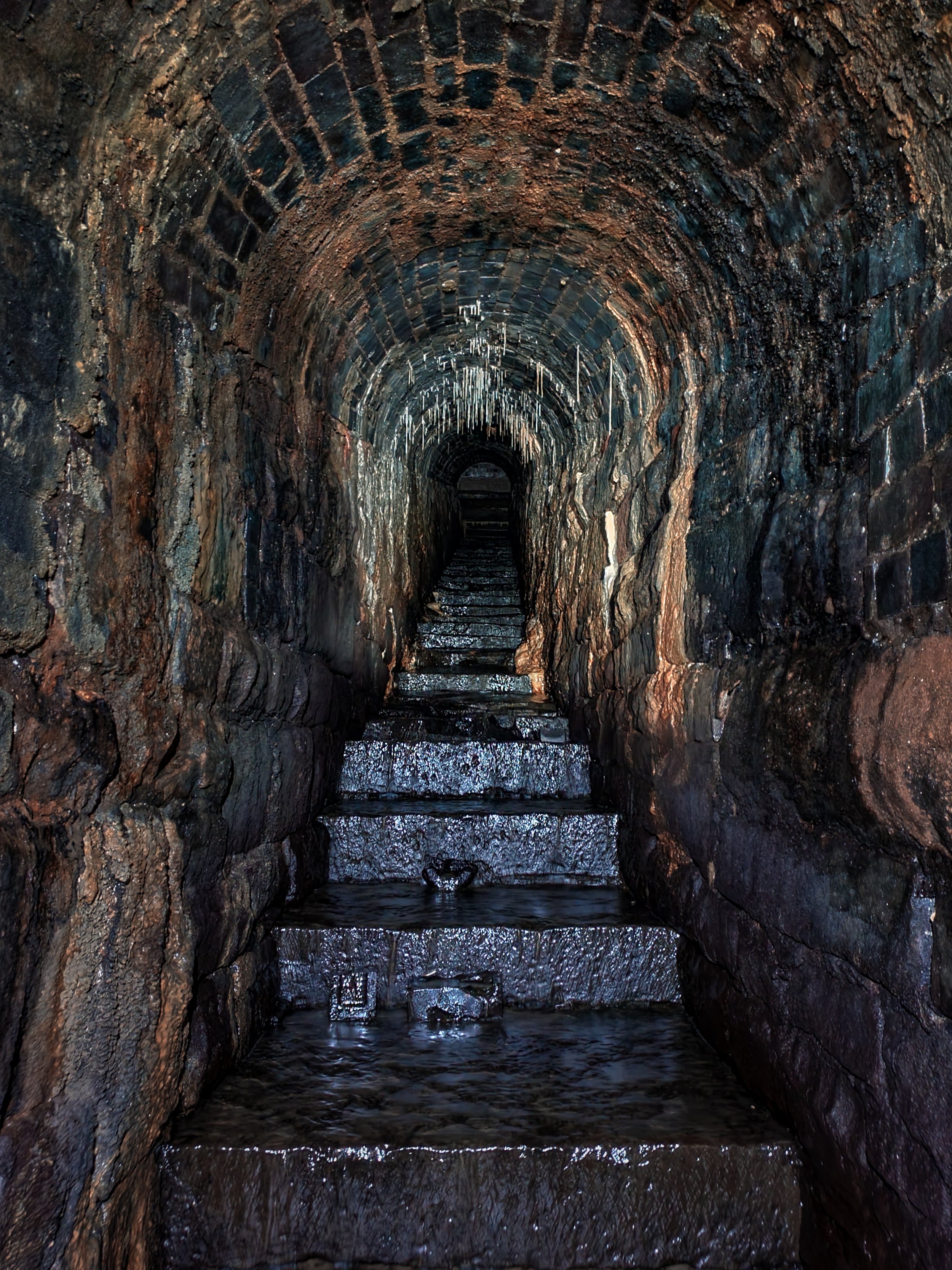 It gradually shrinks as you ascend until you meet a channel only a few feet in height with a small box opening at the other end.