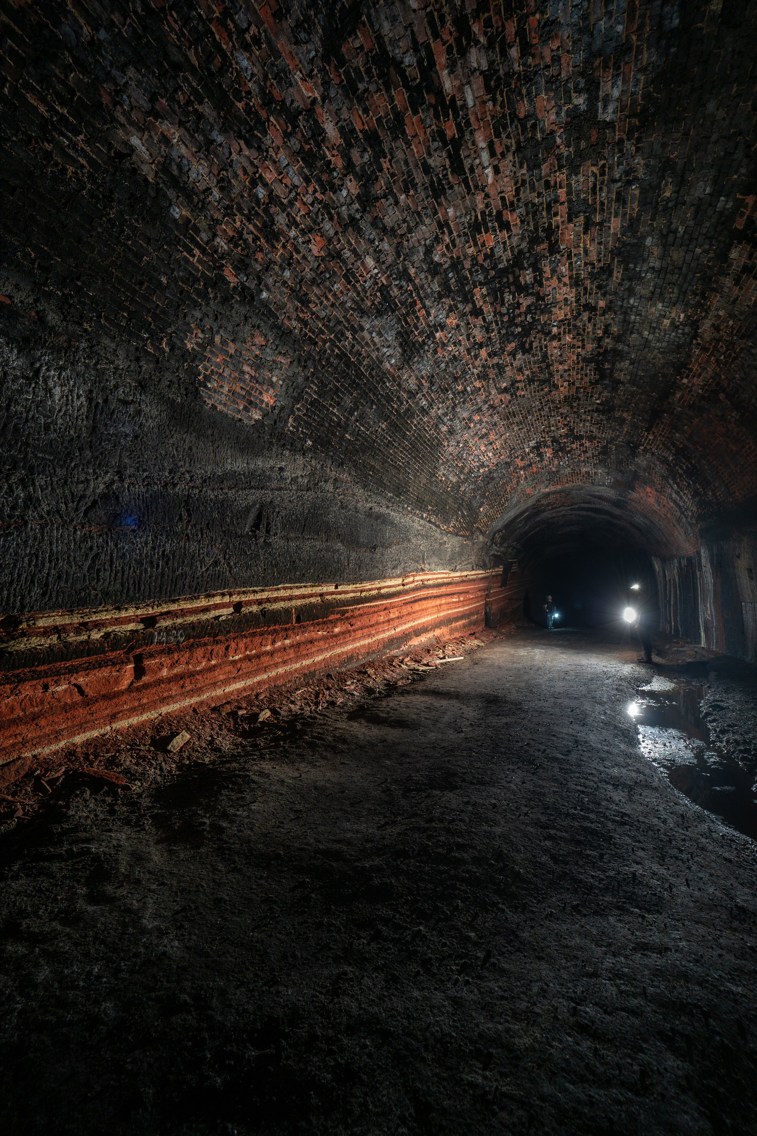 The decline of the tunnel is highlighted by the different earth layers within the rock.