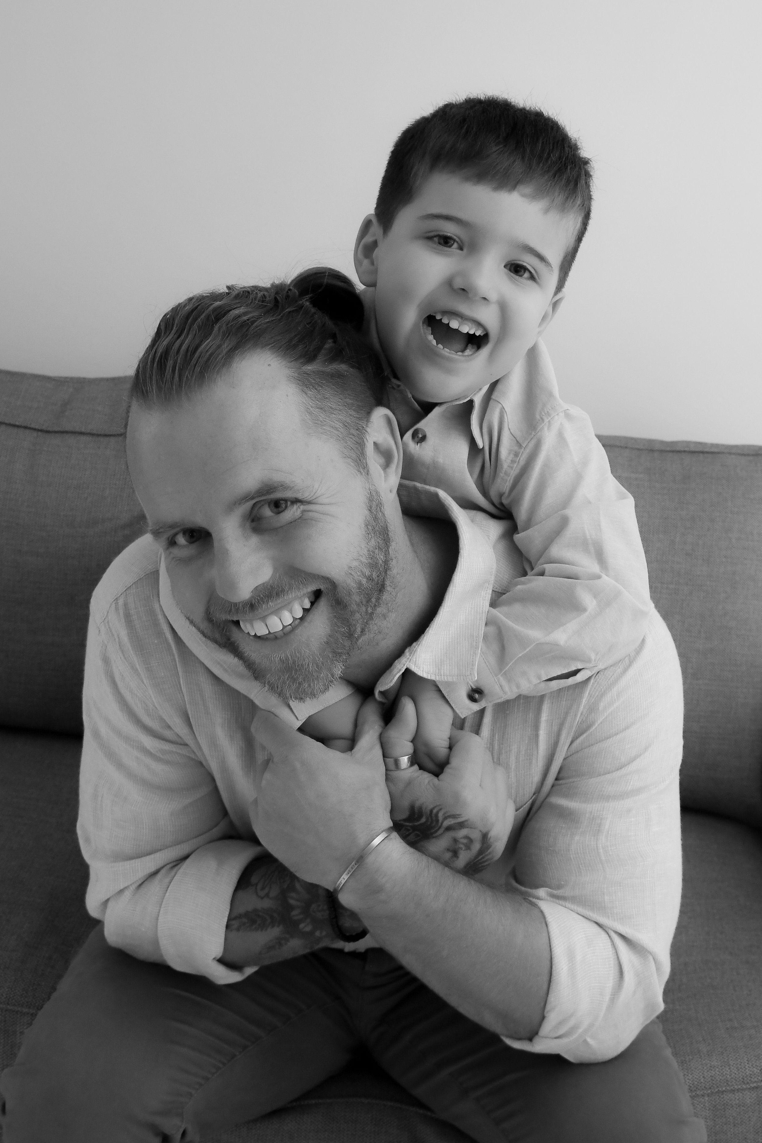 son hugging dad over his shoulders