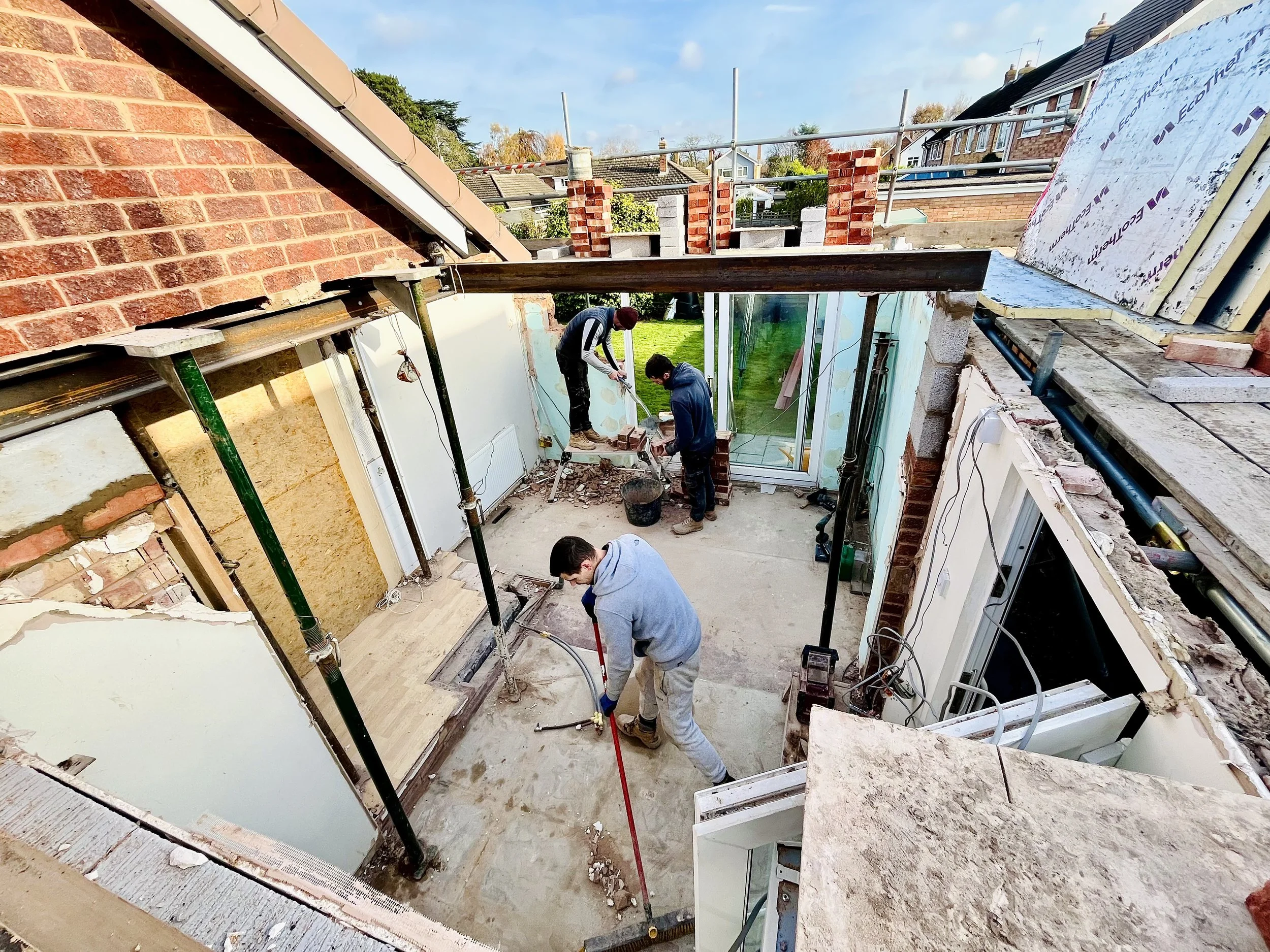 Oranssi technician working on a roof project