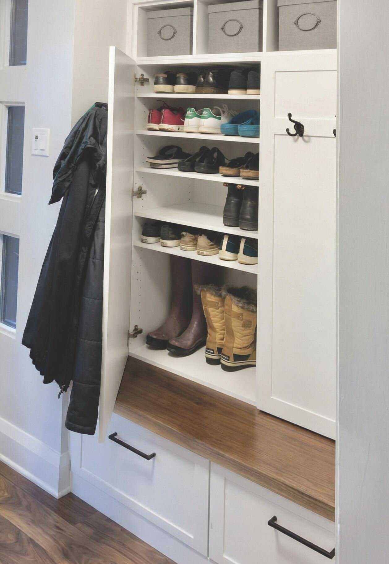 Custom mudroom cabinet with hidden shoe storage shelves and adjustable boot compartment by Bob and Mark's Custom Cabinets Pembroke