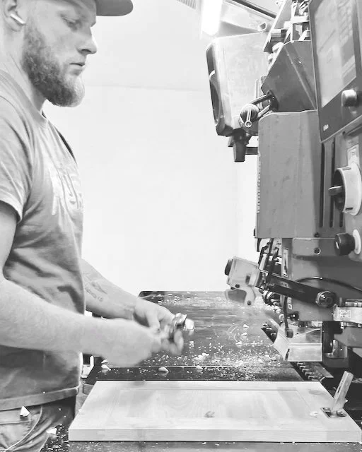 Craftsman finishing a custom cabinet door in the Bob and Marks workshop Pembroke Ontario