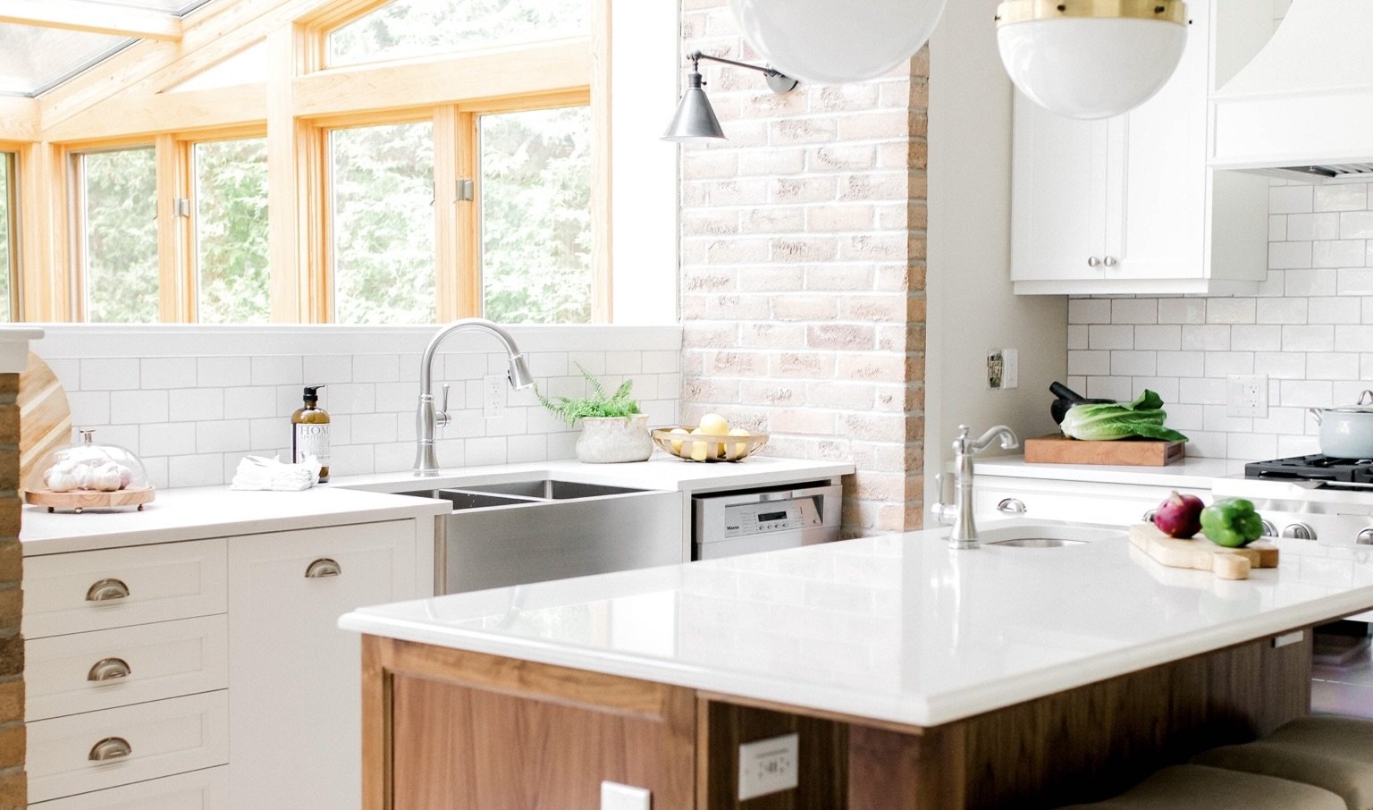 White cabinets with walnut island quartz countertop and farmhouse sink kitchen renovation Pembroke Ontario
