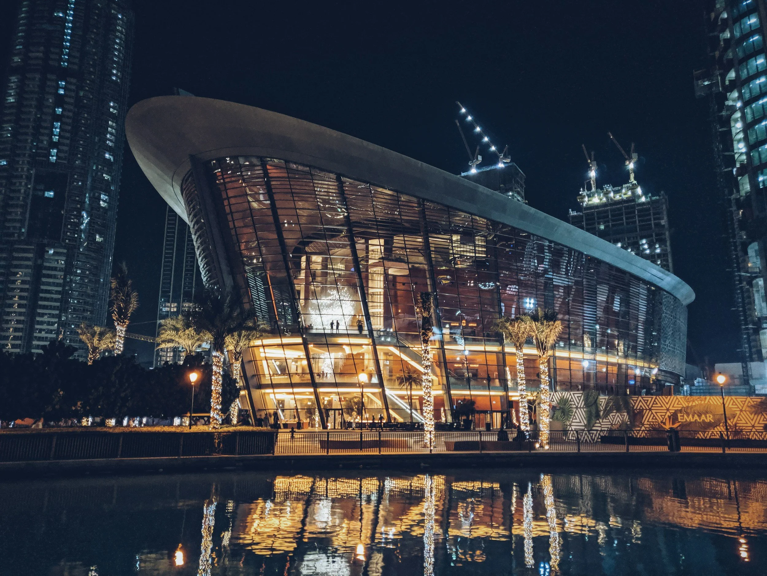 Dubai Opera house by waterfront night photo of architecture