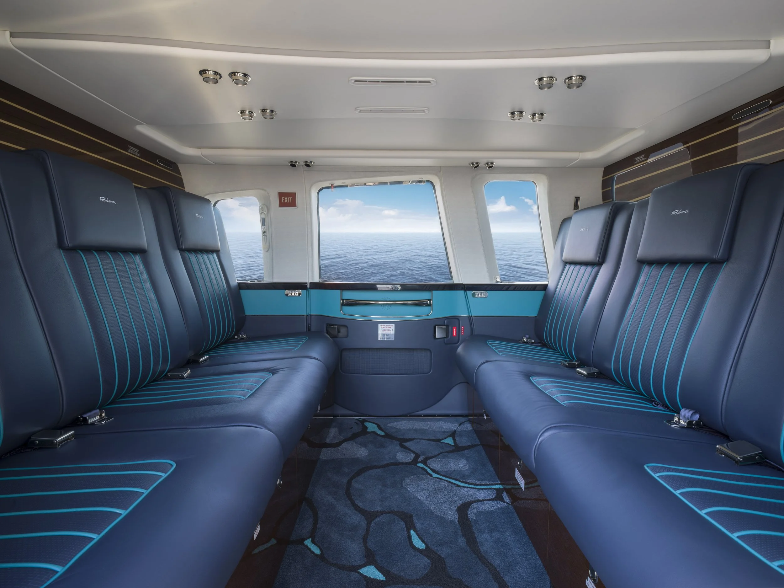 Flexjet Riva Volare helicopter interior design of cabin and view of sea