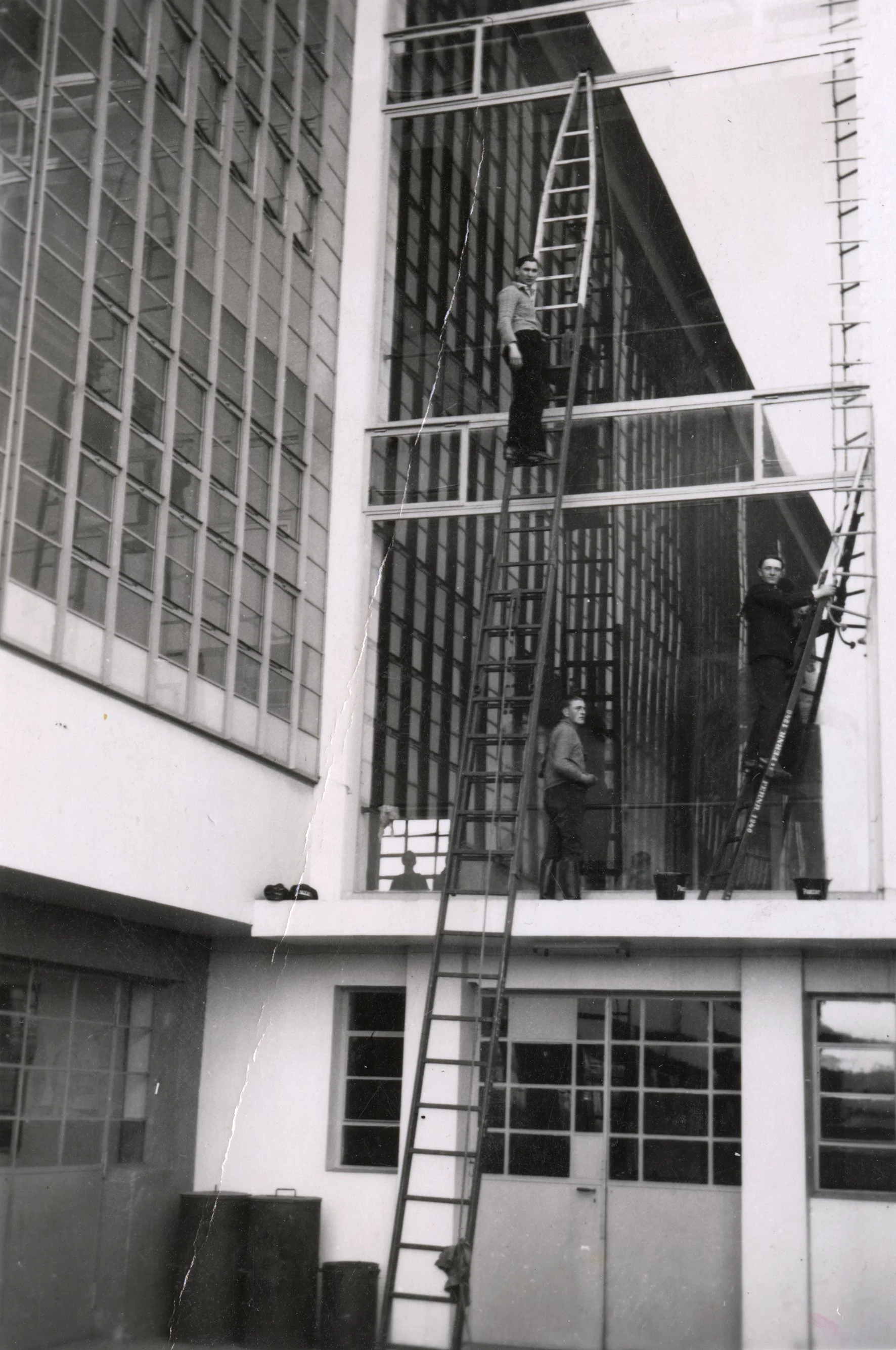 Workers cleaning the iconic glass curtain wall of the Bauhaus workshop wing in Dessau