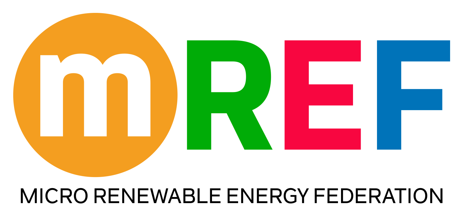 Close-up of a colorful M&M's candy with a white lowercase 'm' on an orange background, featuring green, red, blue, and orange sections.