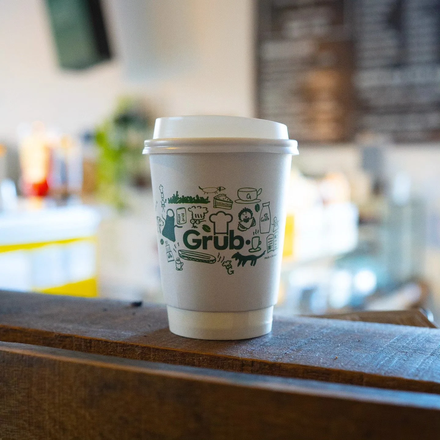 Grub Fresh Food branded coffee cup inside the Aberdeen cafe