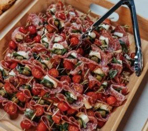 Gourmet canapés by Grub, Aberdeen catering experts – featuring salami, mozzarella, olives, cherry tomatoes, and fresh herbs on skewers, perfect for events and receptions.