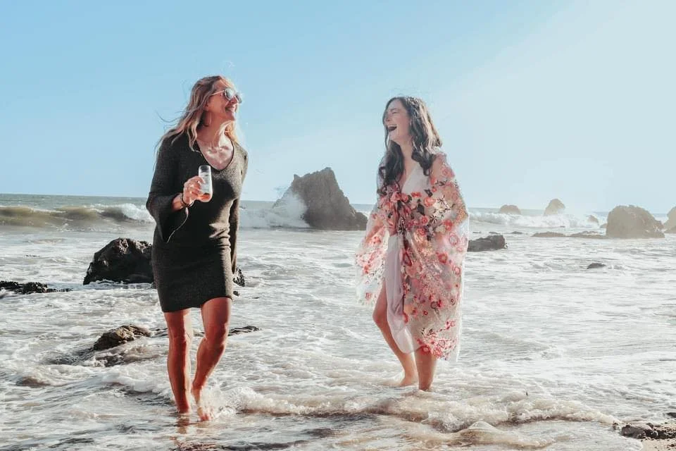 Alignment Coach Sarah Grace plays on the beach with a coaching client