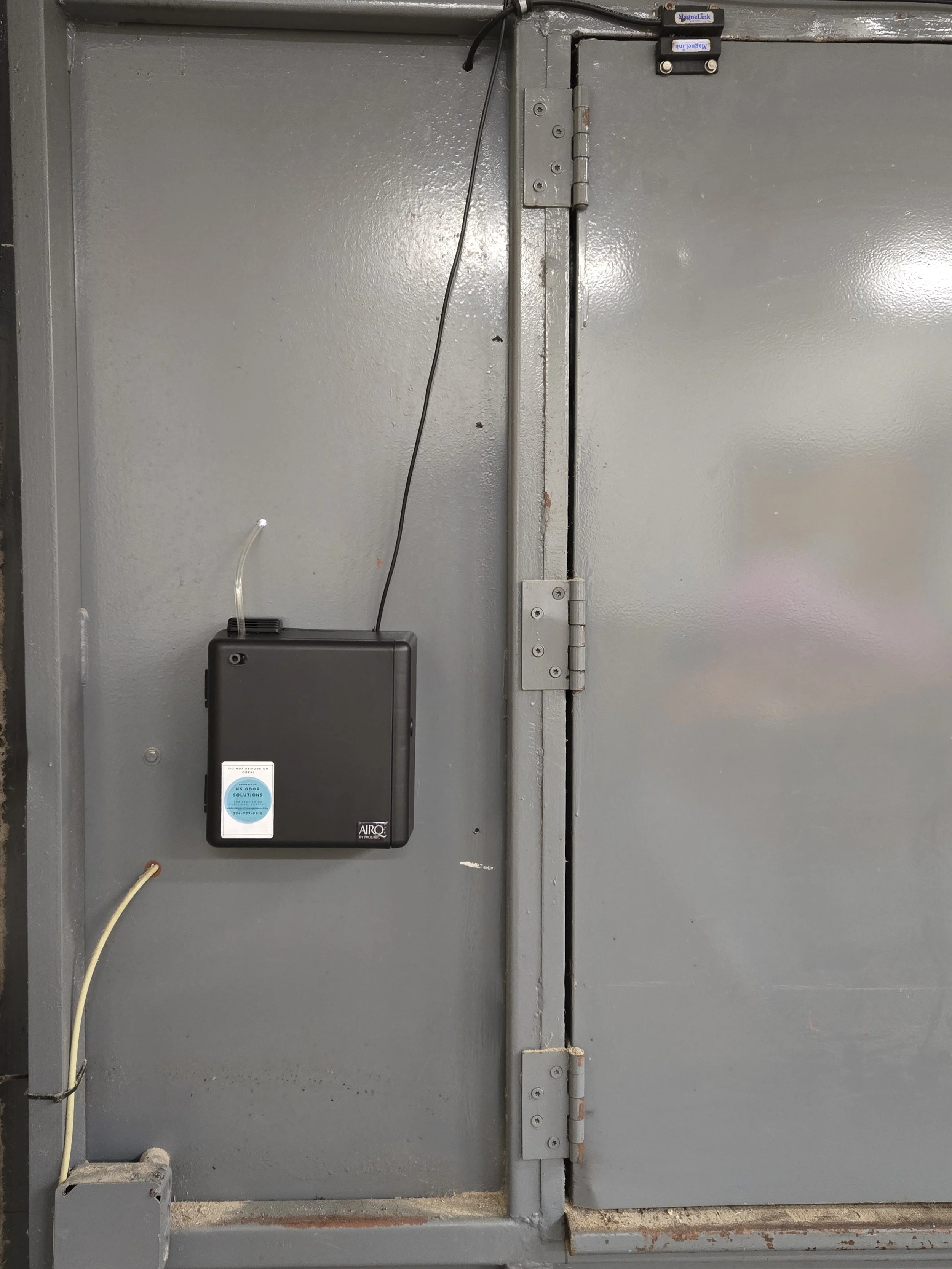 stinky trash compactor connected to building trash chute deodorization odor neutralizing vapor