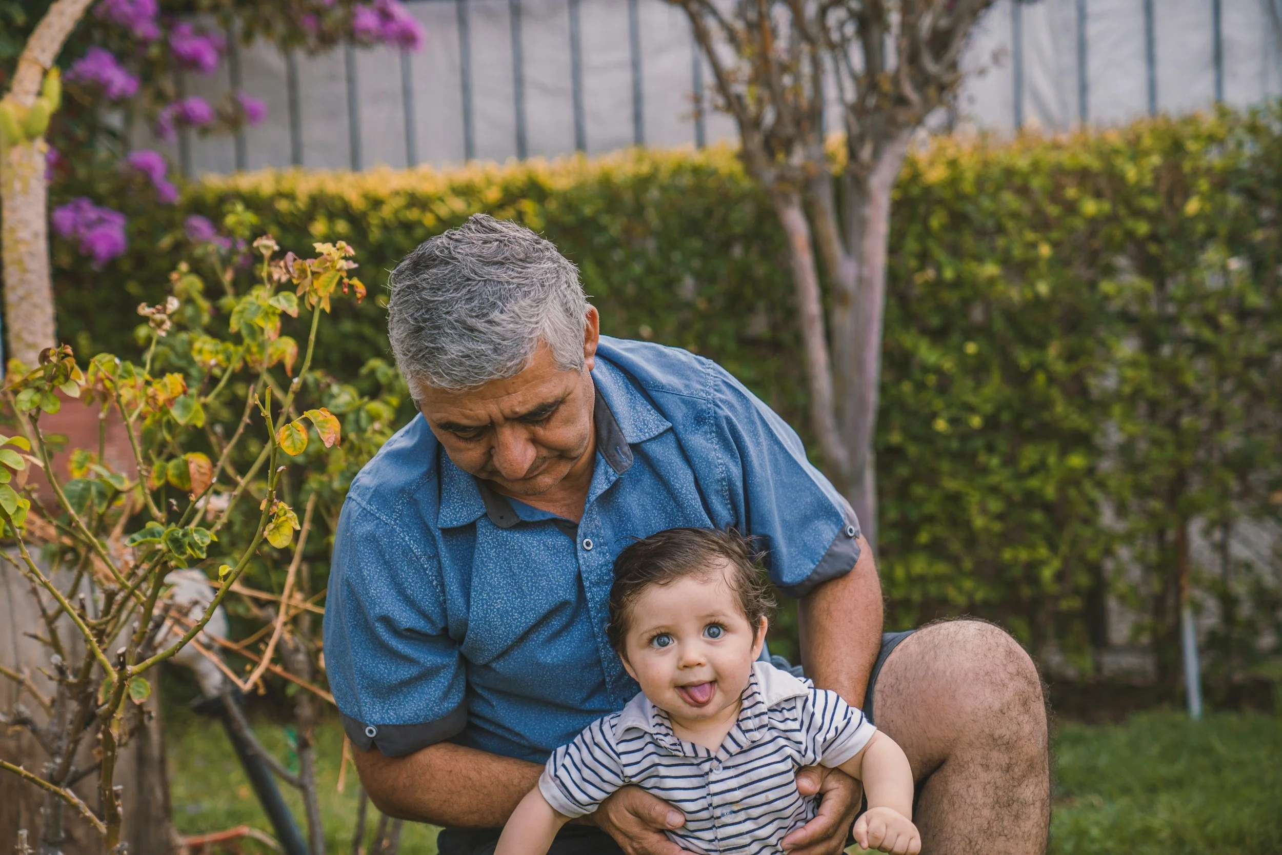 Grandfather caring for his young grandchild outdoors, reflecting grandparents as primary caregivers.