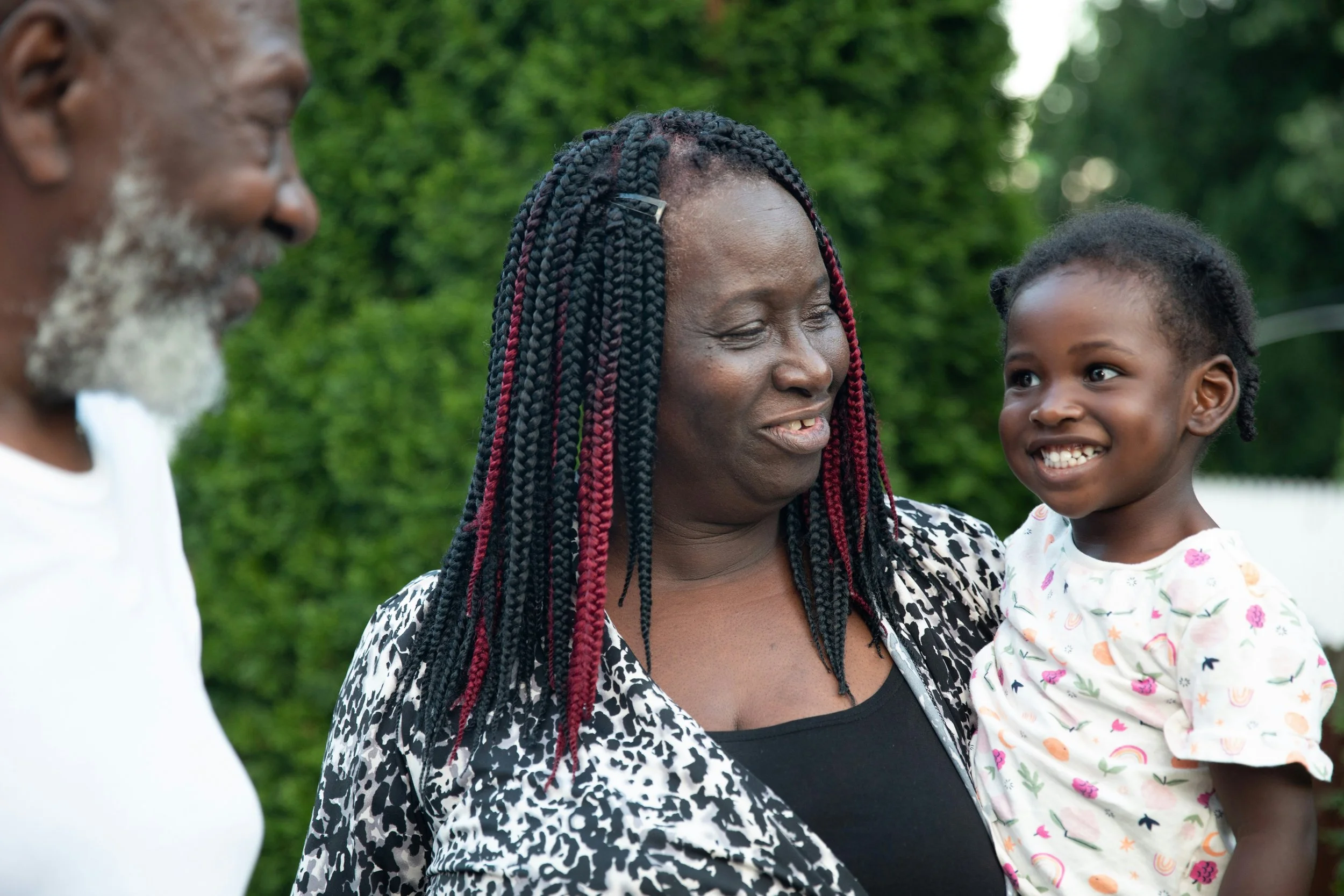 Grandparents expressing love toward their grandchild, showing the emotional role of caregivers raising grandchildren.