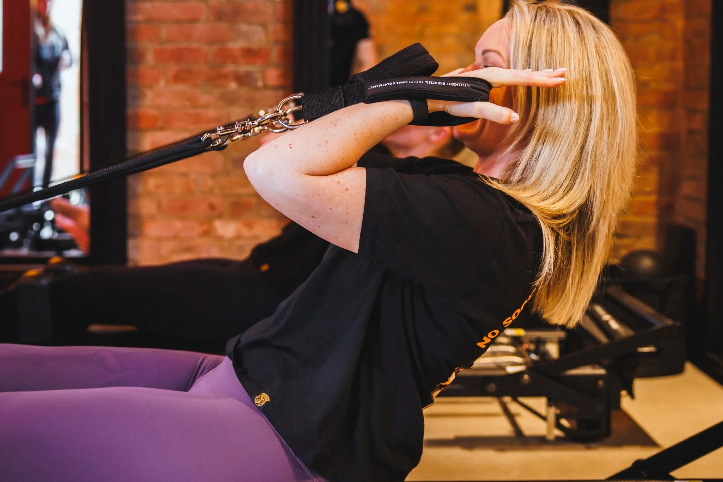 woman doing bicep curl on reformer