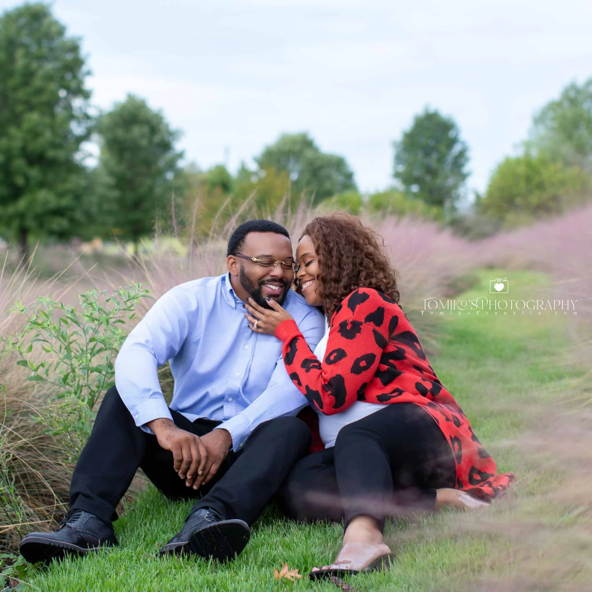 Birmingham engagement photos of a couple holding hands on a rooftop with warm golden hour tones.