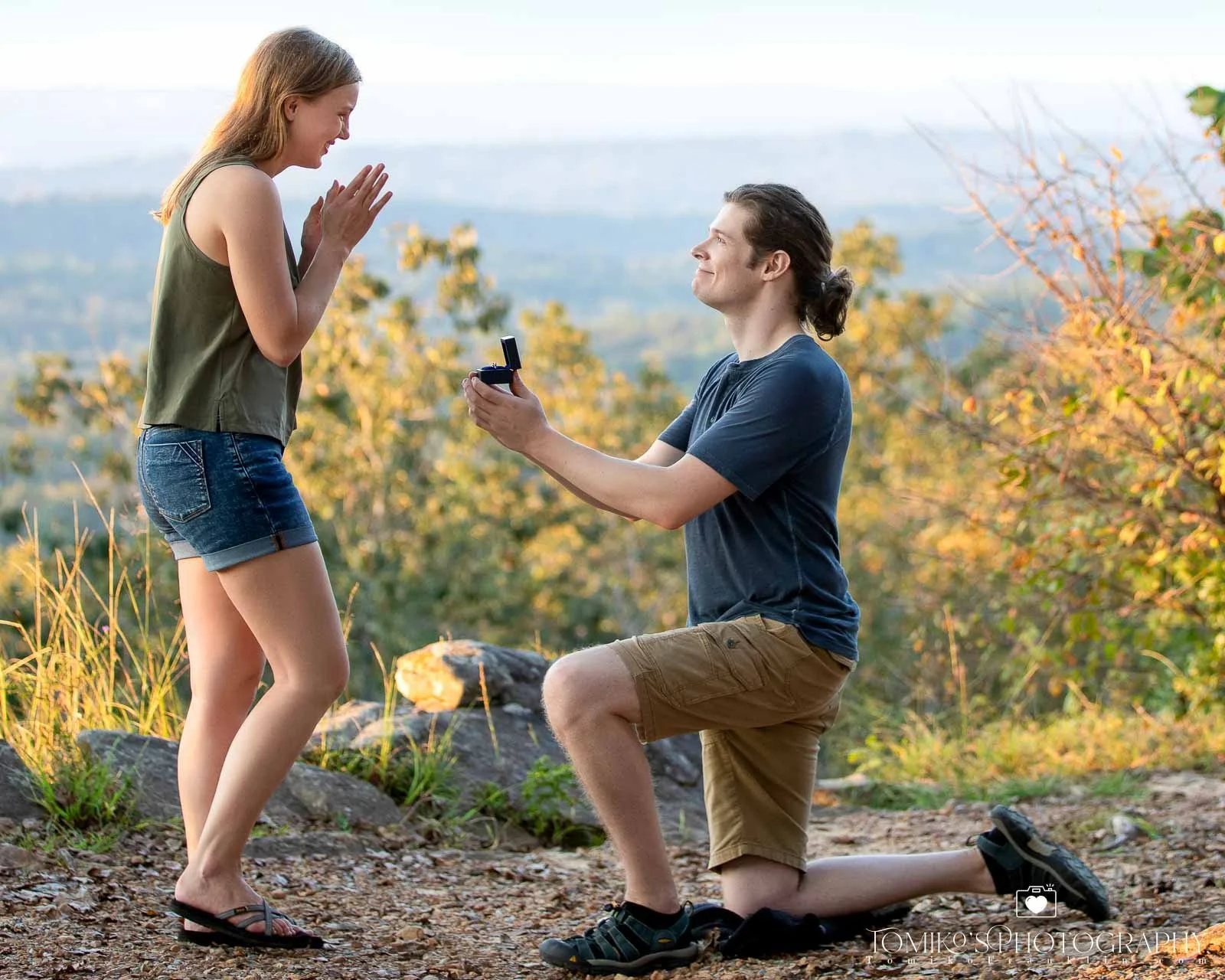 A photo of a guy on his keens saying i do