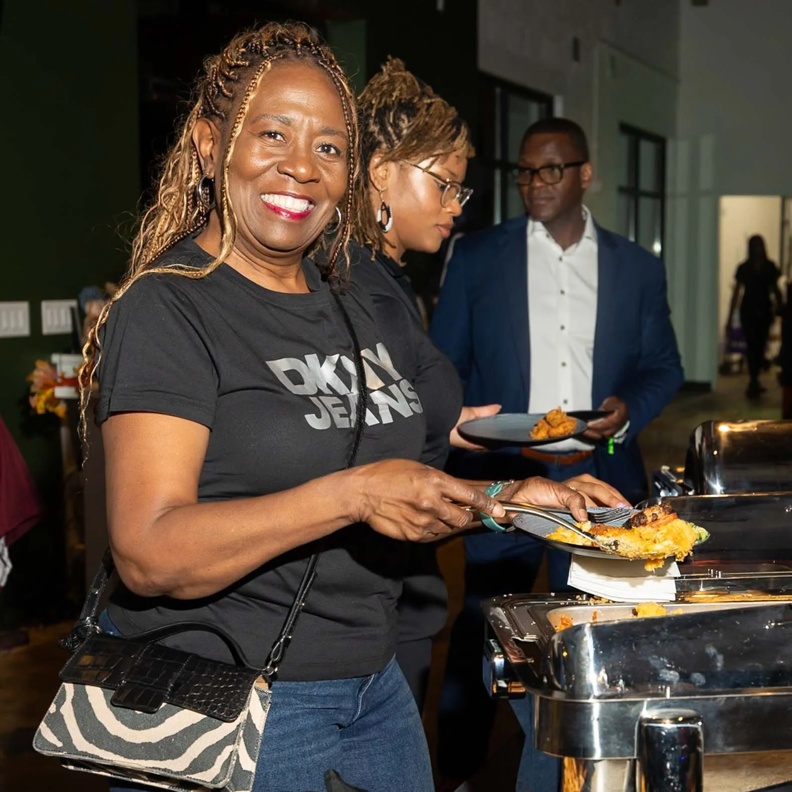 A professional photography photo of a woman at a family event holding food