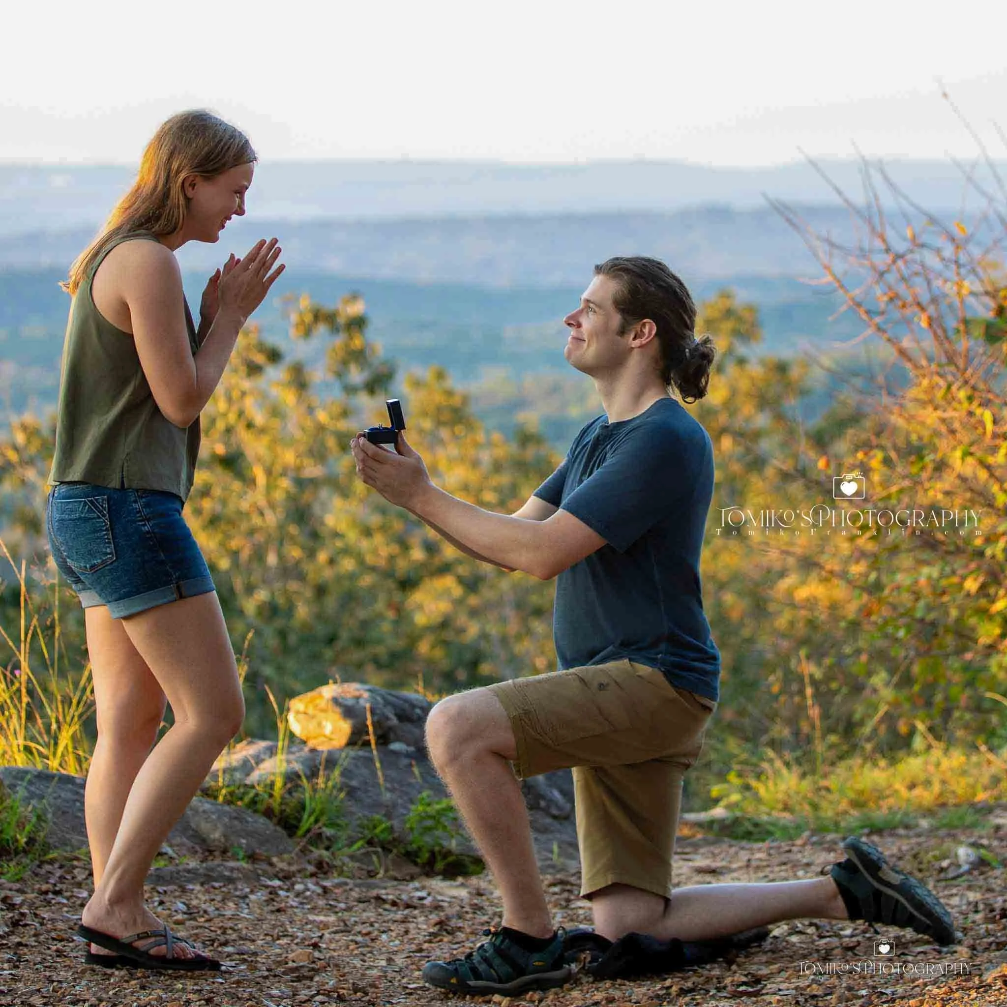 Surprise proposal at Oak Mountain State Park with emotional reaction captured in soft, romantic lighting by Tomiko’s Photography.