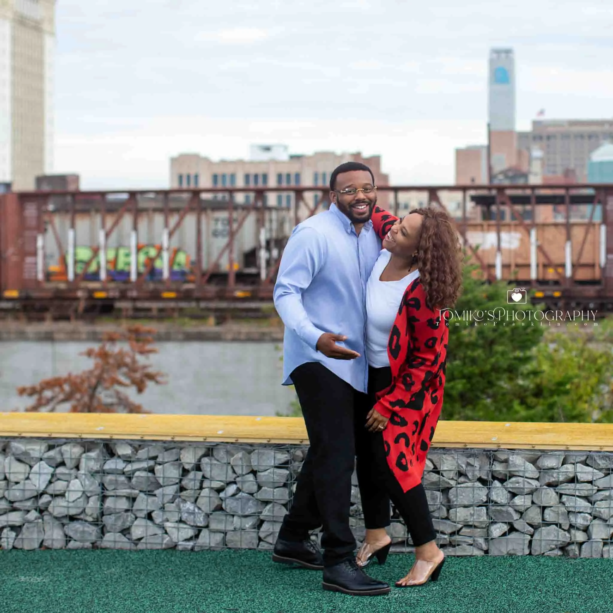 Golden hour rooftop engagement portrait featuring a Birmingham couple in soft, romantic lighting.